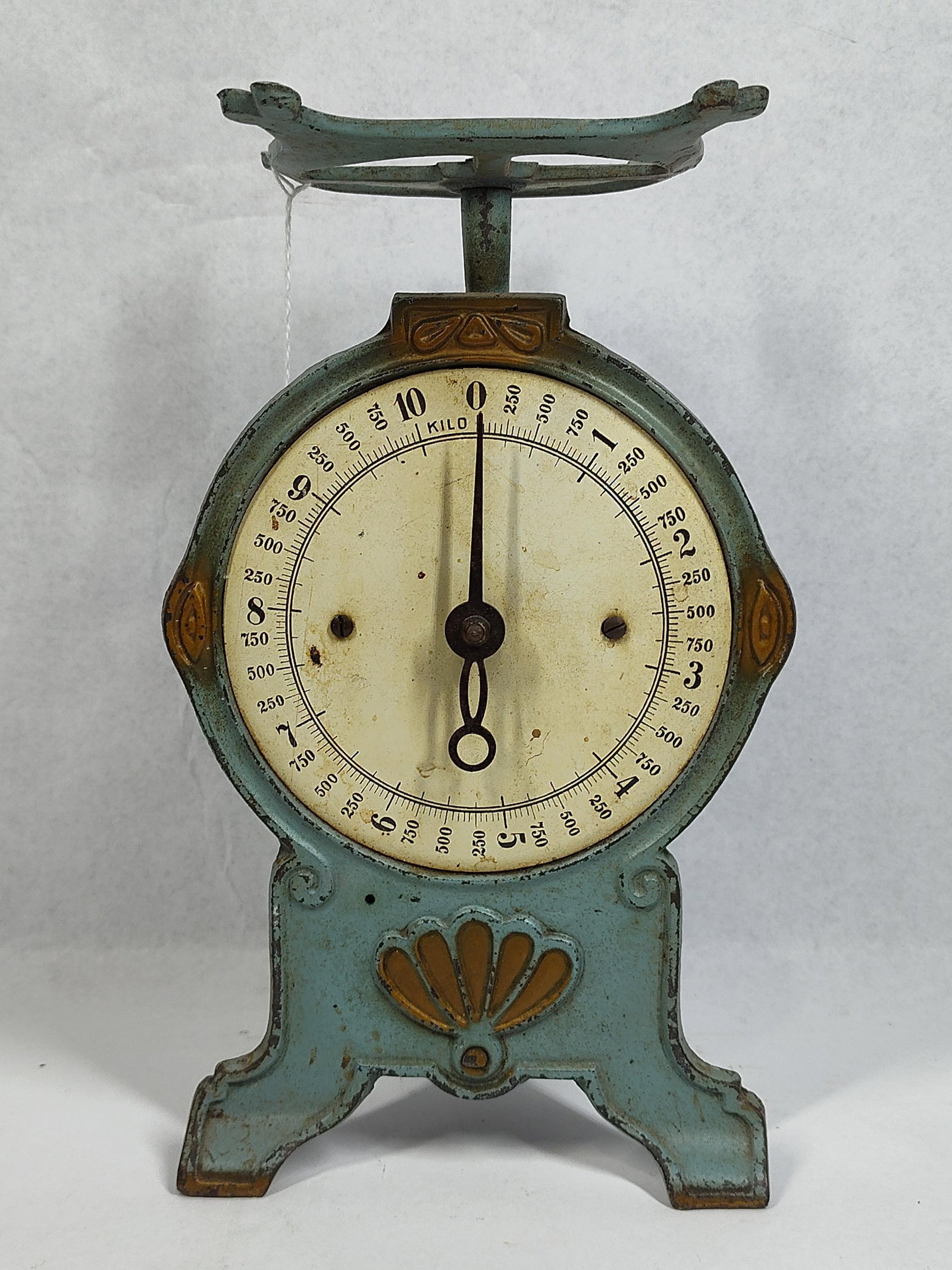 Pelouze Attrib. Cast Iron Kitchen Scale: This antique upright kitchen or utility scale features a cast iron frame with a pale blue-green painted finish and gilt-tone decorative accents. The design is attributed to the Pelouze Deluxe Family S