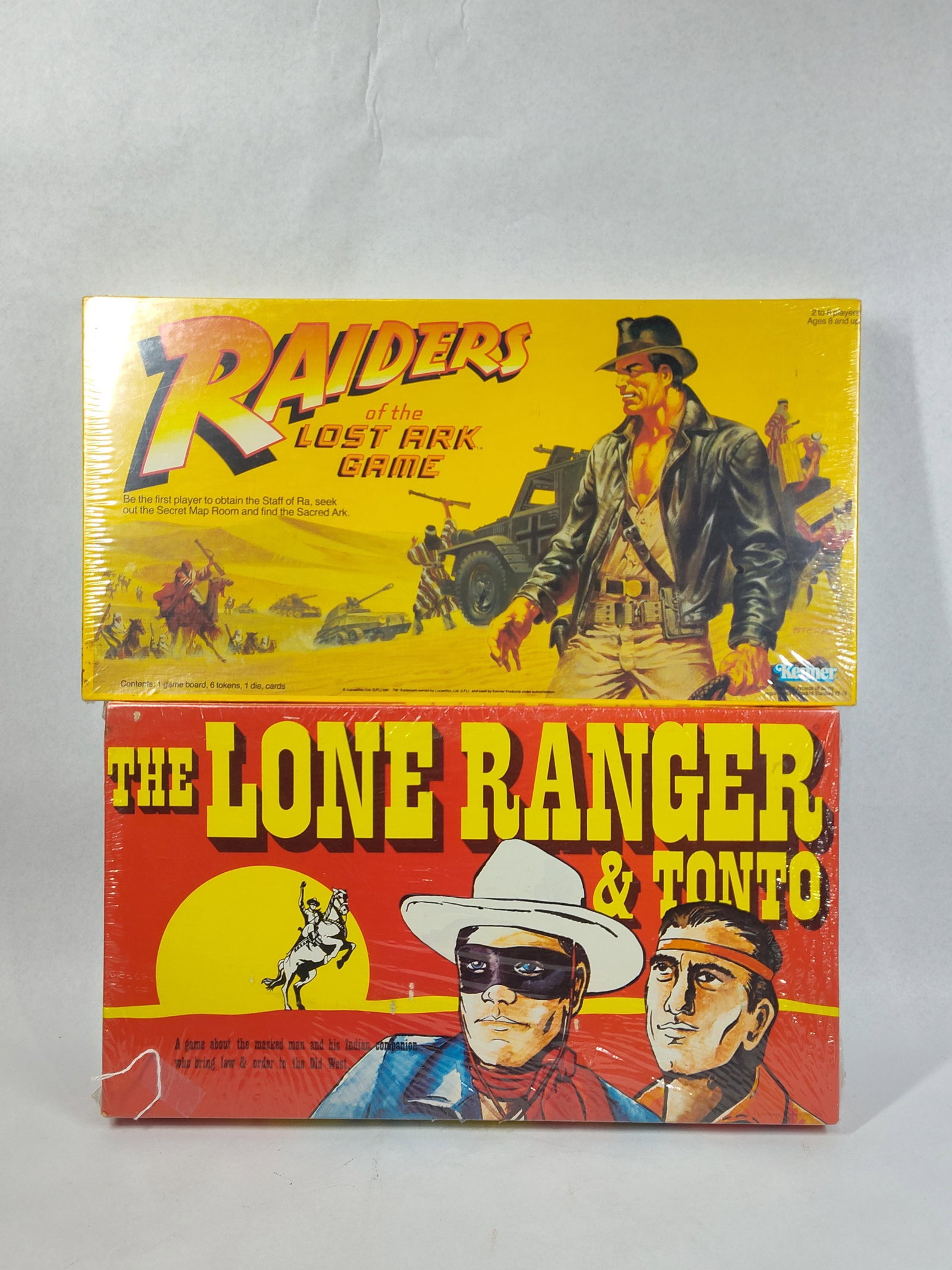 Pair Kenner & Warren Sealed Board Games: This lot features two vintage tabletop board games based on popular media franchises from the late 1970s and early 1980s. The first item is the Raiders of the Lost Ark Game, manufactured by Kenner
