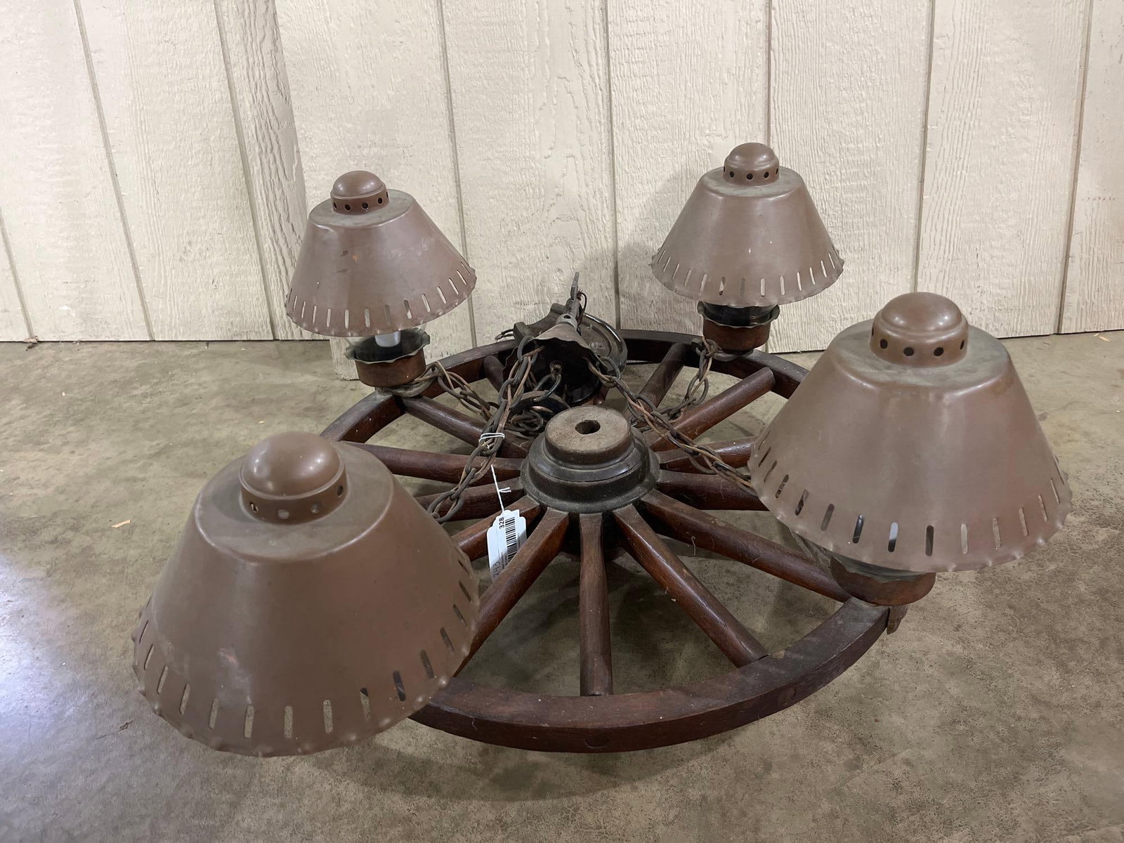 Wagon Wheel & Horseshoe Chandelier: 24in A vintage four light chandelier designed in a rustic Western or ranch style. The fixture features a dark stained wooden wagon wheel frame as the primary structure. Four electrical sockets are