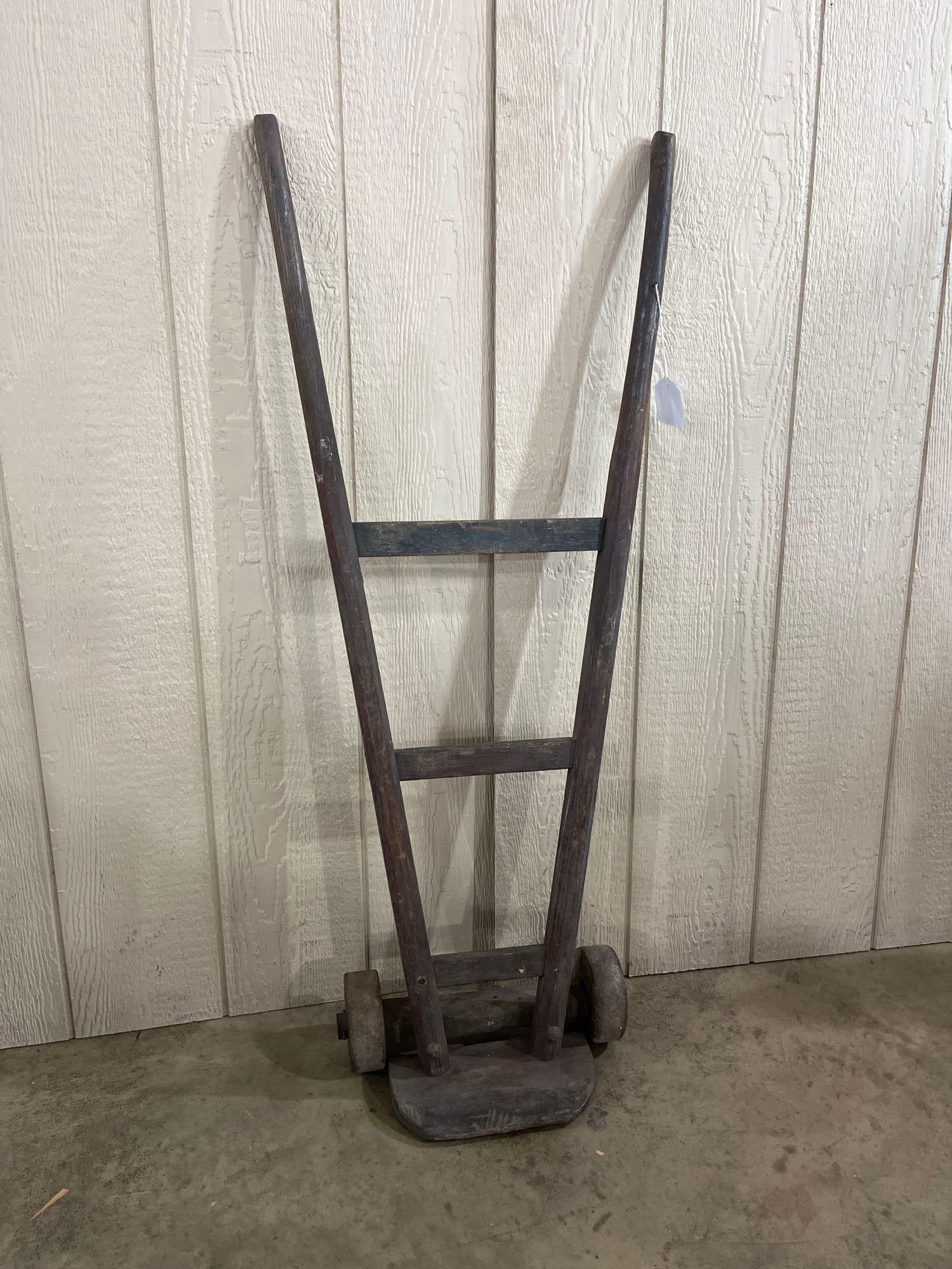 Antique V-Style Wood & Iron Hand Truck: This antique industrial hand truck, also known as a sack barrow or dolly, features a flared V-style frame. The structure is built from solid hardwood upright handles connected by three horizontal
