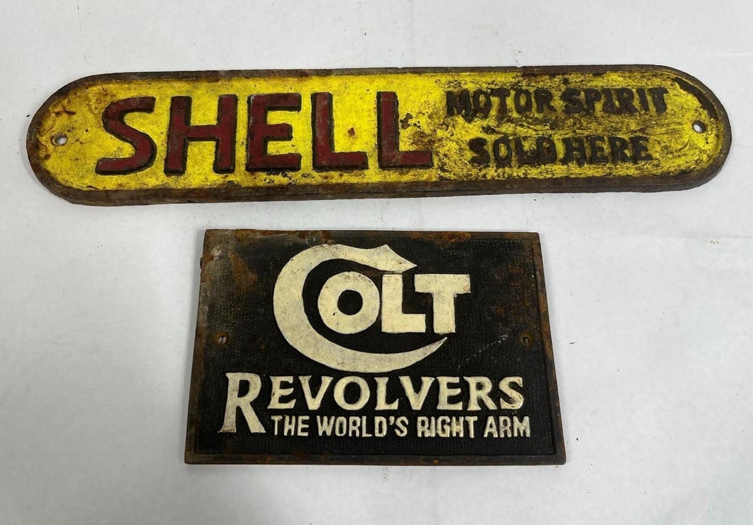 Pair Shell & Colt Advertising Plaques: This lot consists of two cast iron advertising plaques produced in a vintage style. The first item is a Shell Motor Spirit sign featuring an oblong form with rounded ends and two pre-drilled mounting