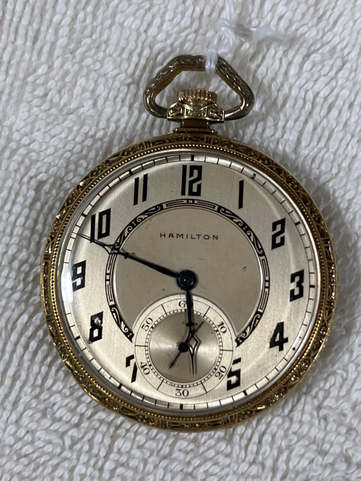 14 K Solid Gold Hamilton Pocket watch: 17 jewel. Monogrammed back case with detailed trim work. Running condition. Dated 1928 with a presentation award scripted inside to John B. Barnes. Serial number 3133177