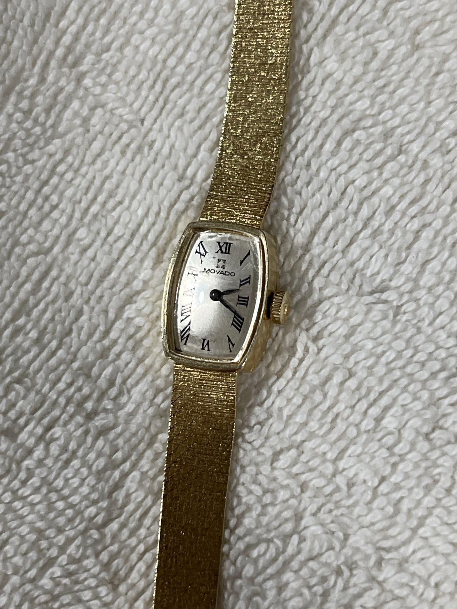 Movado 14 K Gold Cocktail Ladies Wrist Watch: Textured 14 K yellow gold integrated mesh bracelet with rectangular dial and Roman numerals. Both band and watch are gold. Not running. 
