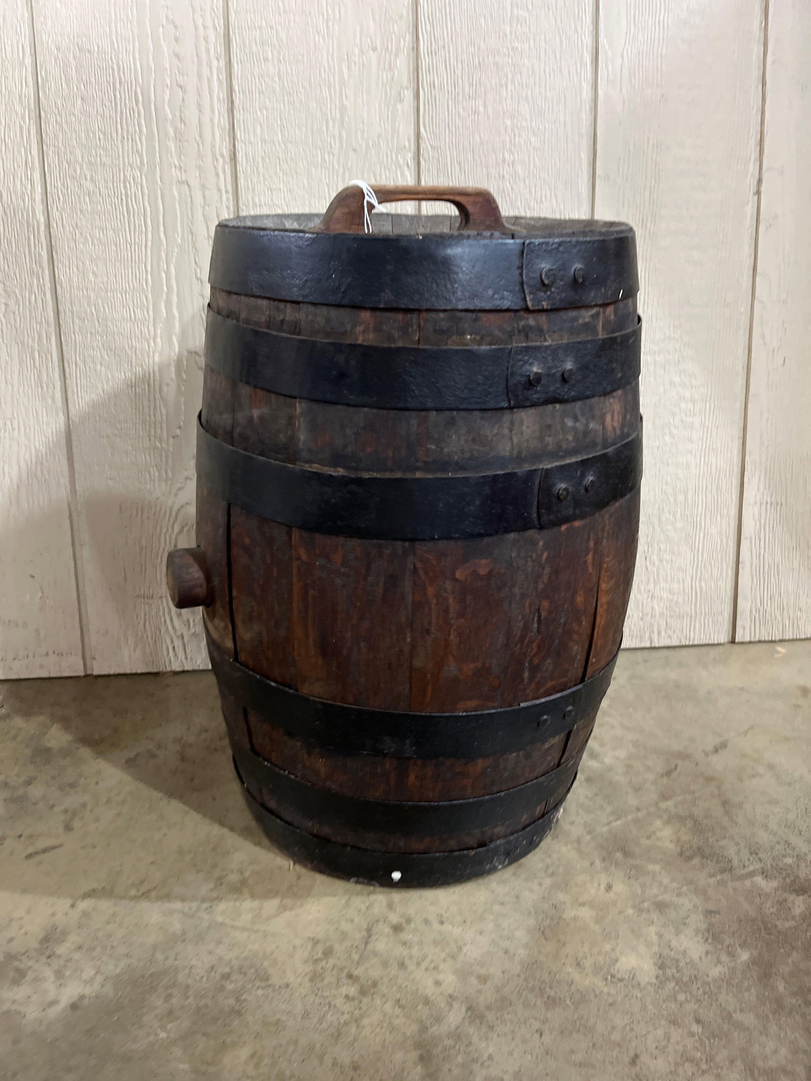 Antique Wood Barrel Canteen w/ Iron: 21x12.5 This antique coopered vessel, designed as a field worker canteen or portable spirit keg, is constructed from dark-stained wooden staves. The structure is reinforced by five black-painted iron 