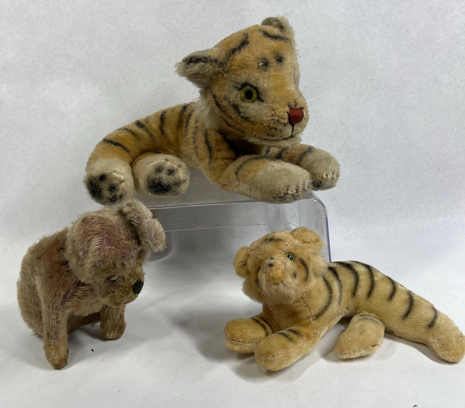 3 Steiff-Style Mohair Animal Toys: A collection of three vintage mohair stuffed animal toys comprising two tigers and one small dog. The figures are crafted from mohair plush fabric and feature glass or plastic eyes with embroidered