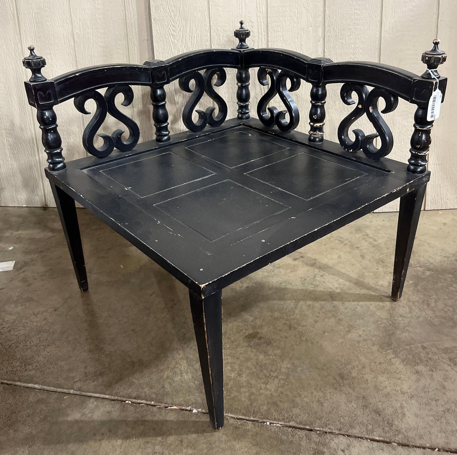 Mediterranean Revival Wood Corner Chair: 28.5x28.5 A corner chair or bench designed in the Spanish Colonial or Mediterranean Revival style, constructed from hardwood with a distressed black painted finish. The piece features a right-angled