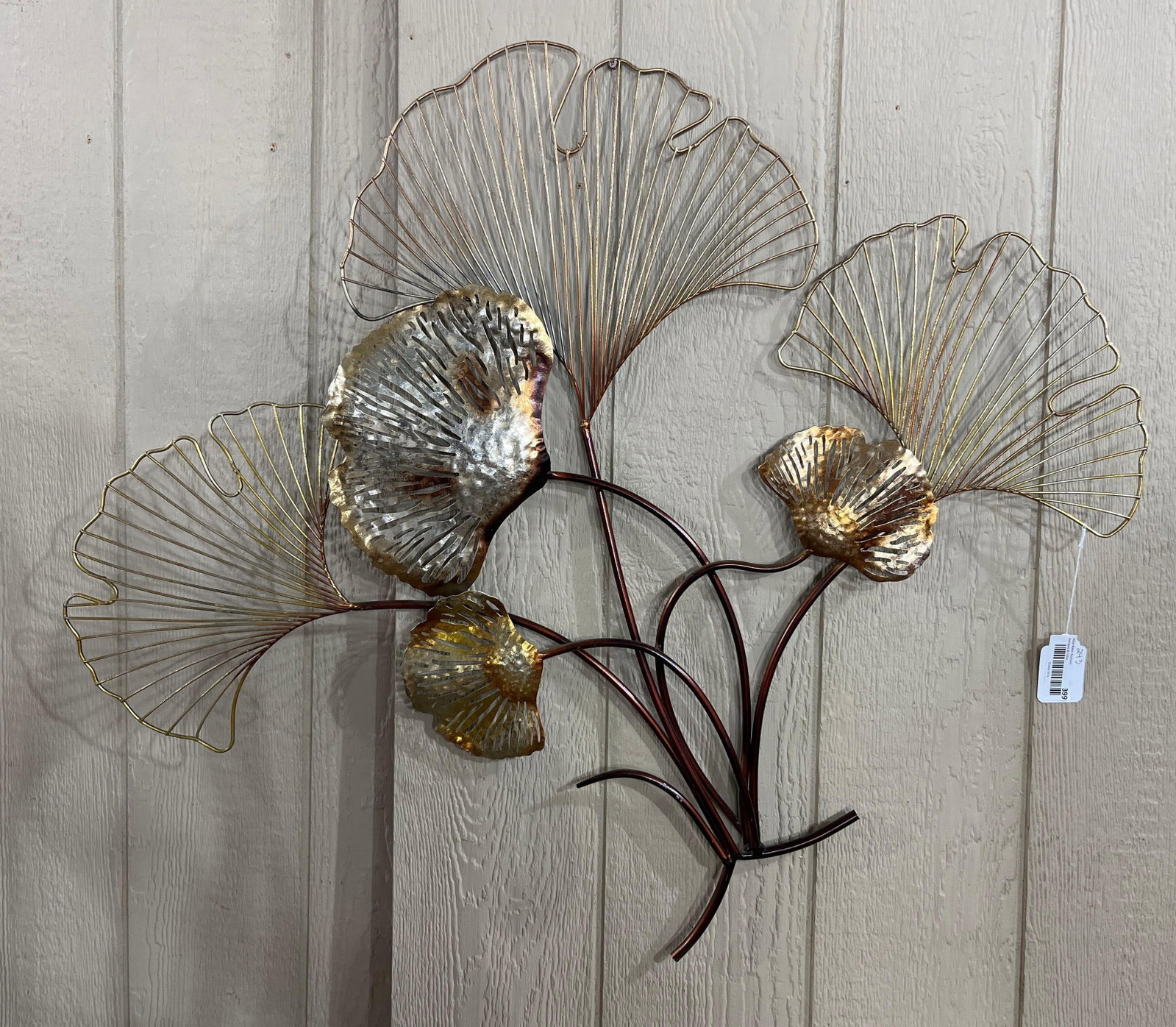 Mixed-Metal Ginkgo Leaf Wall Sculpture: 36x31 This contemporary wall art sculpture is constructed from welded metal and depicts a stylized arrangement of ginkgo leaves. The piece features a multi-tonal design with several distinct finishes