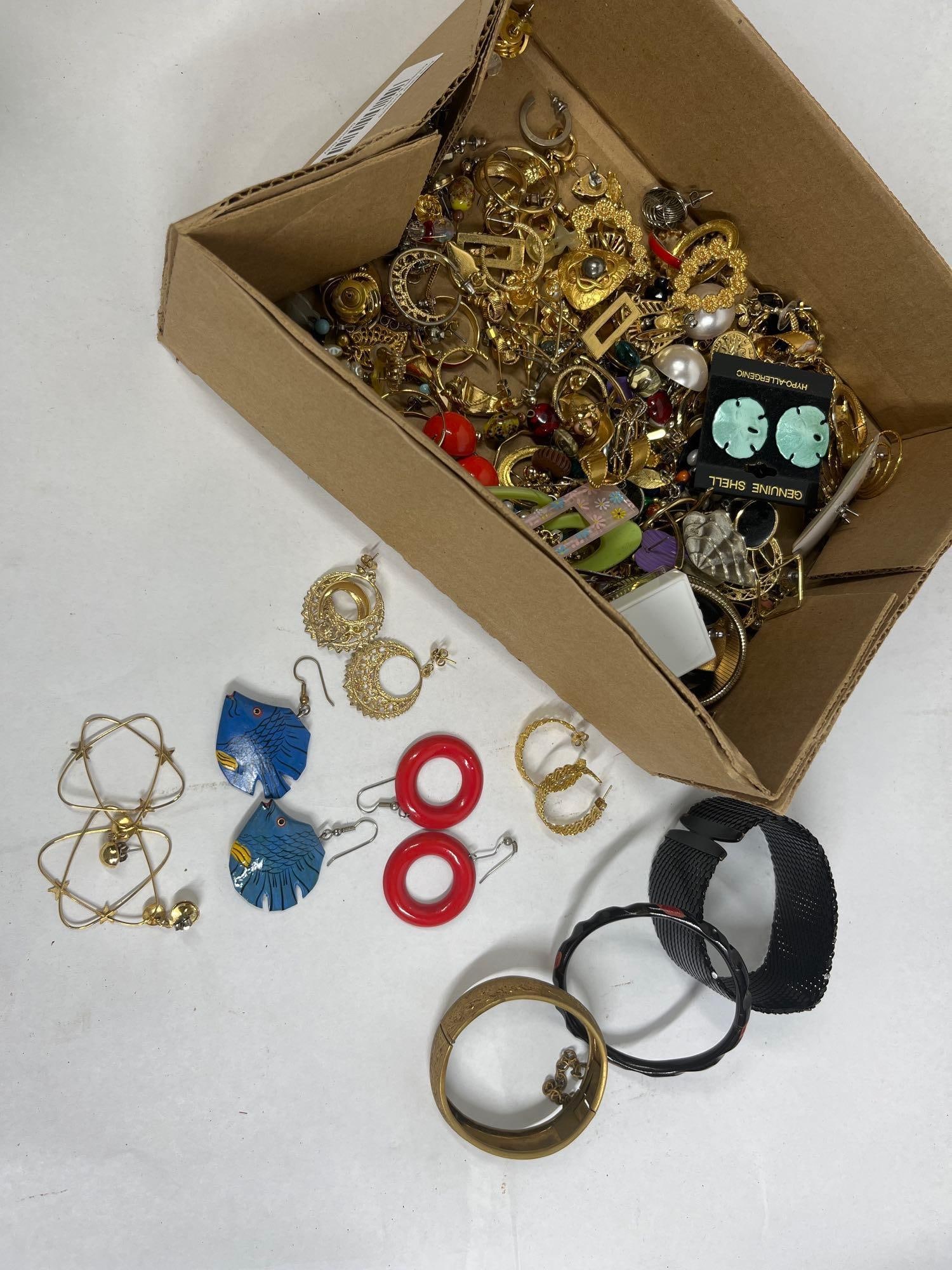 Contemporary Earrings & Bracelets: An assortment of costume jewelry consisting primarily of earrings and several bracelets. The collection features a variety of earring styles, including gold-tone and silver-tone hoops in filigree,