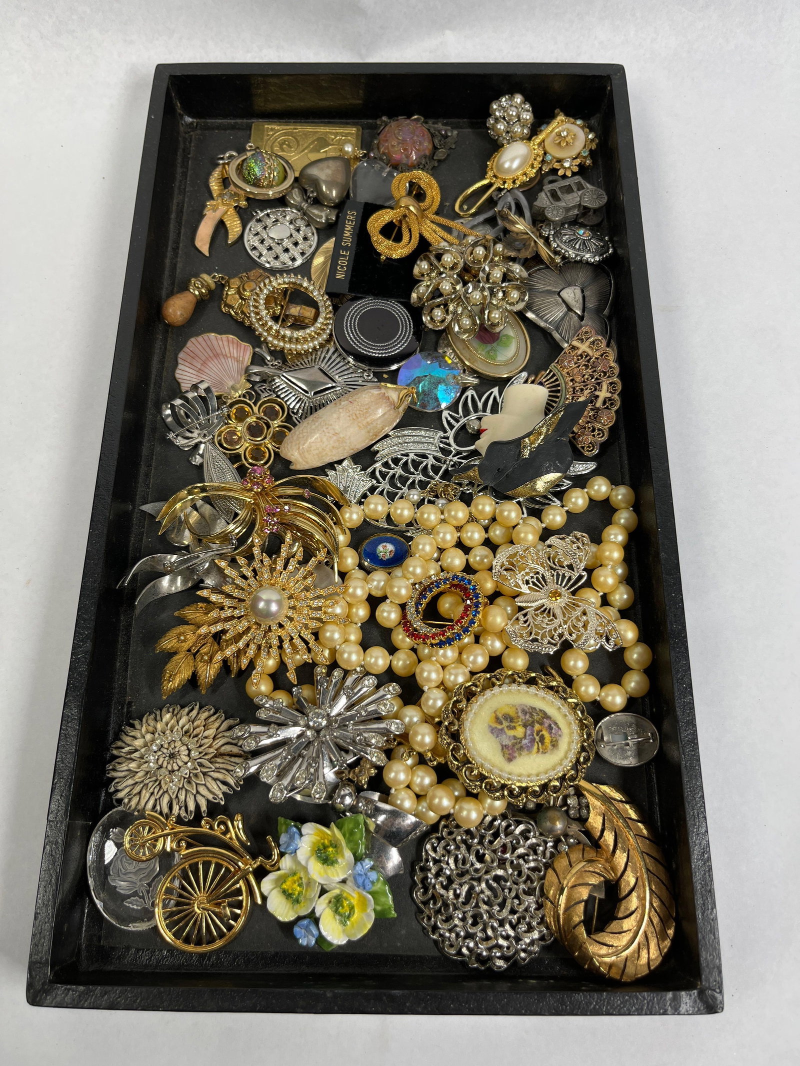 Contemp Costume Brooches & Pins: This collection of costume jewelry features a diverse range of styles including Victorian-revival, mid-century modern, and contemporary designs. The group is primarily constructed from gold-tone and