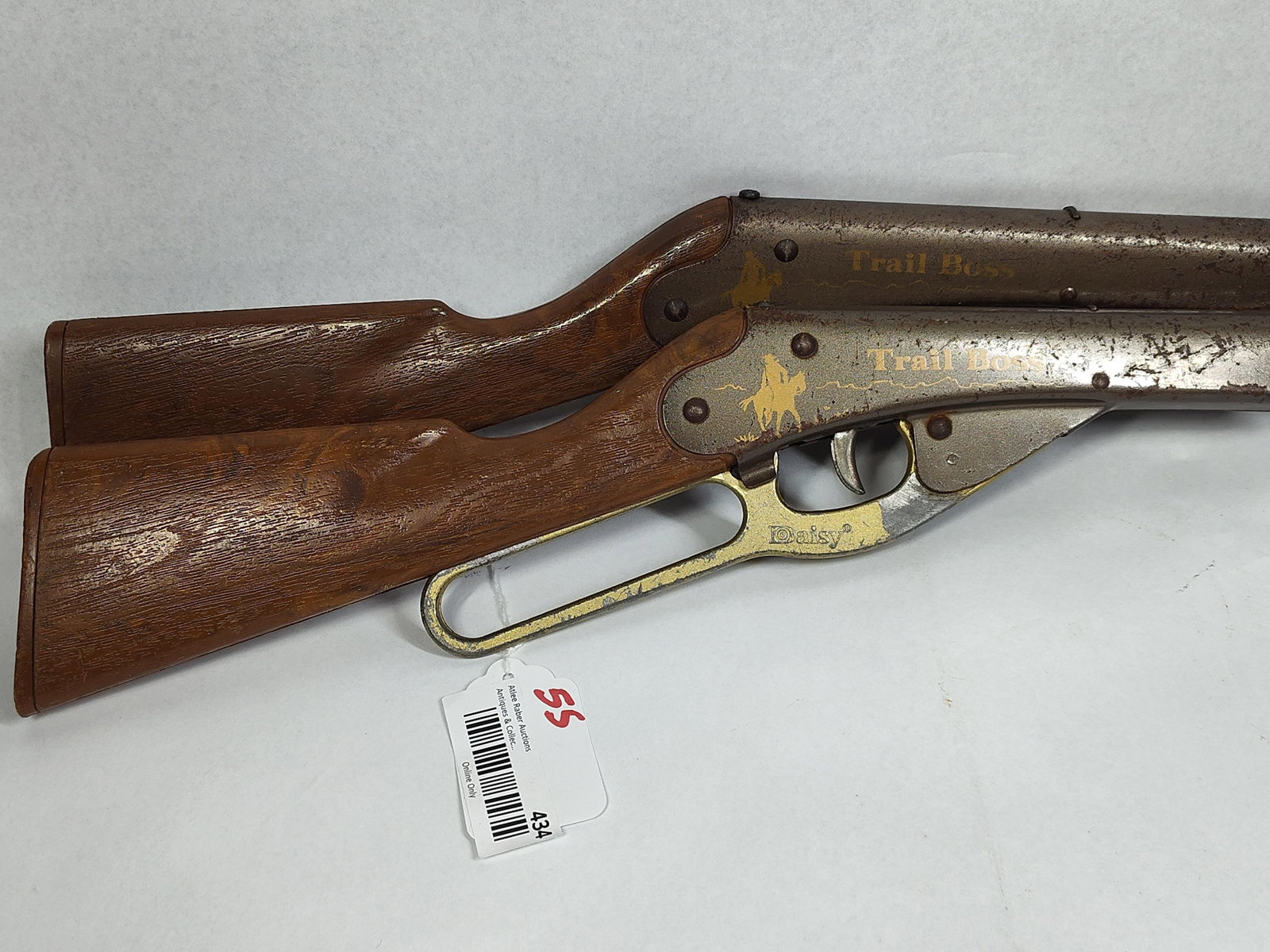 Pair Daisy Trail Boss Toy Pop Rifles: 30in long This lot consists of two vintage toy lever-action rifles manufactured by the Daisy Manufacturing Company. Identified by markings on the receivers as the Trail Boss model, these items are