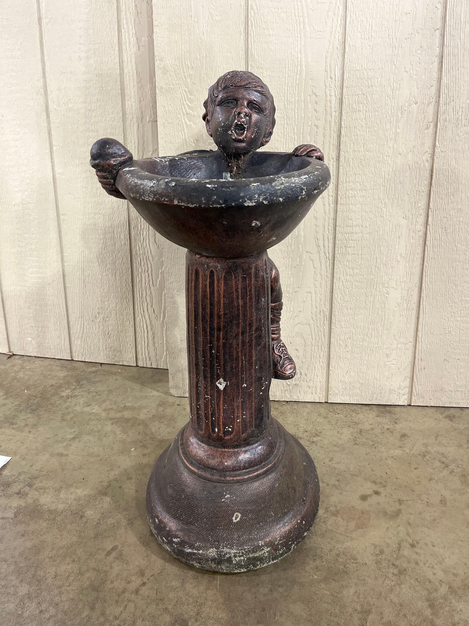 Composite Boy & Ice Cream Cone Fountain: 30in tall This garden pedestal fountain is constructed from a cast composite material with a dark, patinated bronze-tone metallic finish. The figurative design features a young boy in contemporary