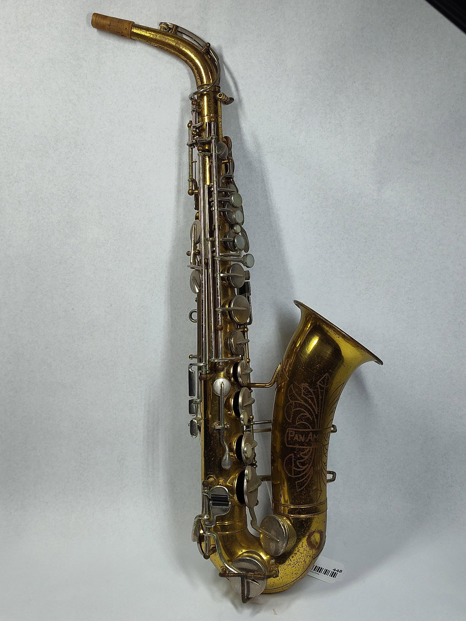 Pan American Brass Alto Saxophone: 26in This vintage alto saxophone was manufactured by Pan American, a subsidiary of C.G. Conn, in Elkhart, Indiana. The instrument is constructed from yellow brass with a gold-colored lacquer finish
