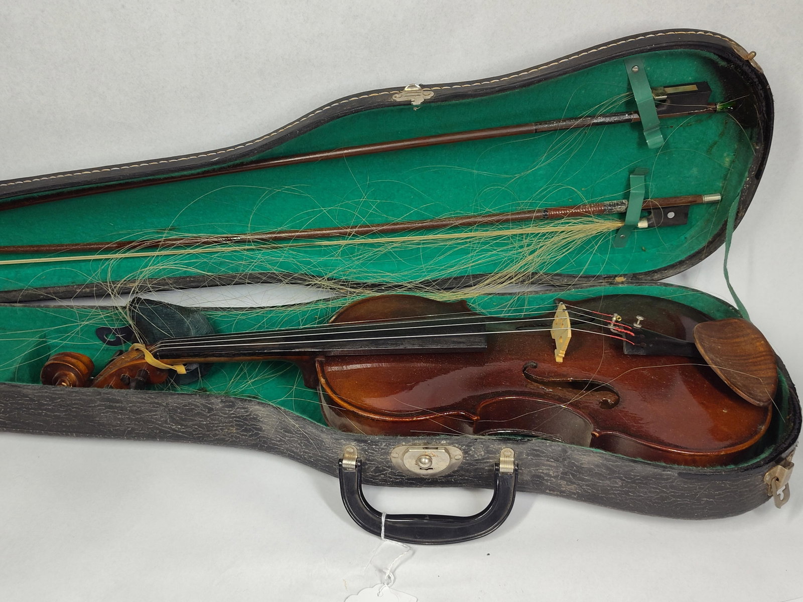 Violin w/ 2 Bows & Alligator Case: 24in violin This violin outfit includes two wooden bows, and a hard carrying case. The violin features a carved wood body with a dark reddish-brown varnish finish. It is equipped with an ebony fingerb