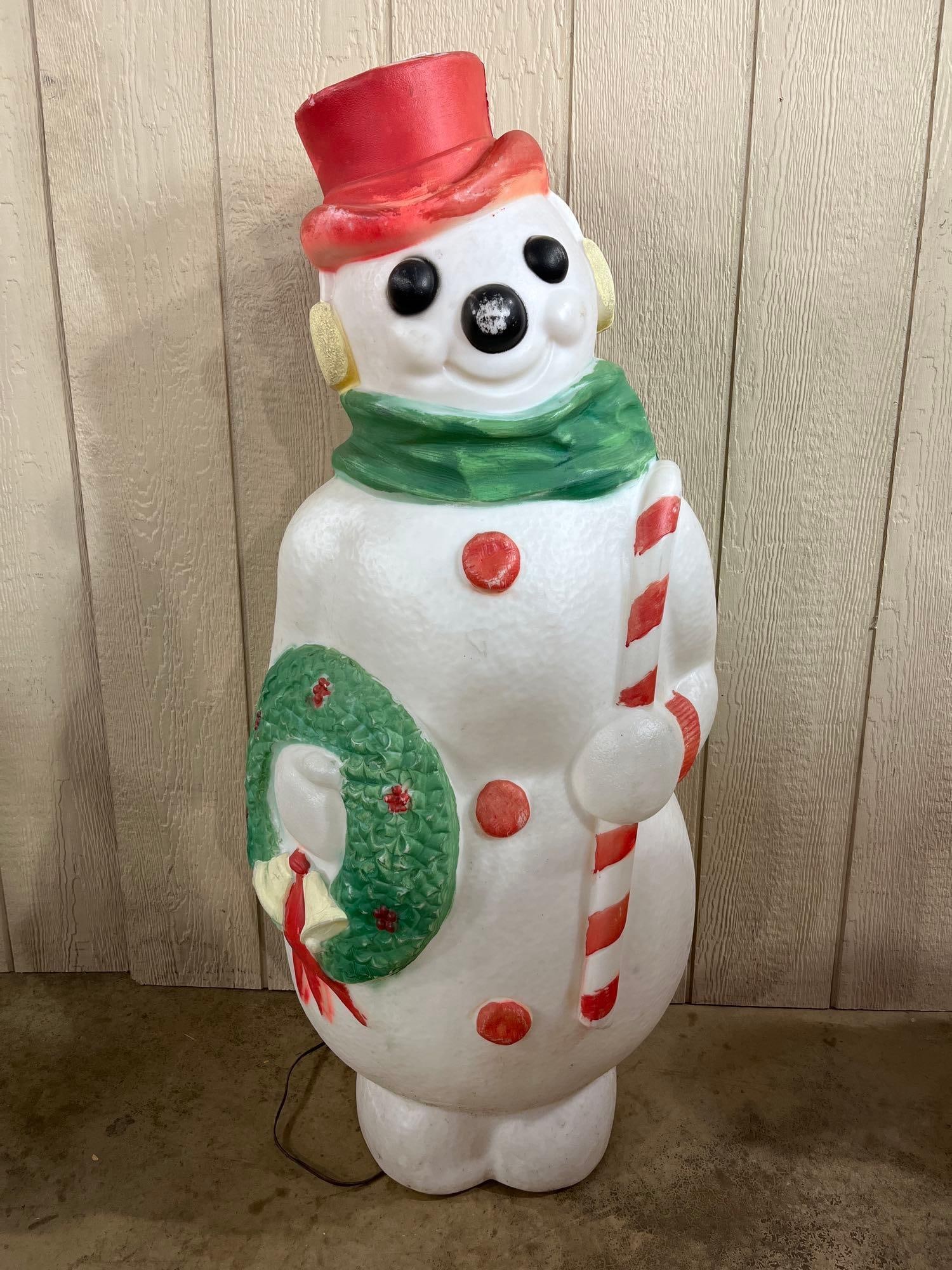 Empire Plastic Corp Snowman Blow Mold: 46in tall This large-scale holiday lawn ornament is an illuminated snowman blow mold, attributed to Empire Plastic Corp. based on distinctive mold characteristics and market consensus. The figure is