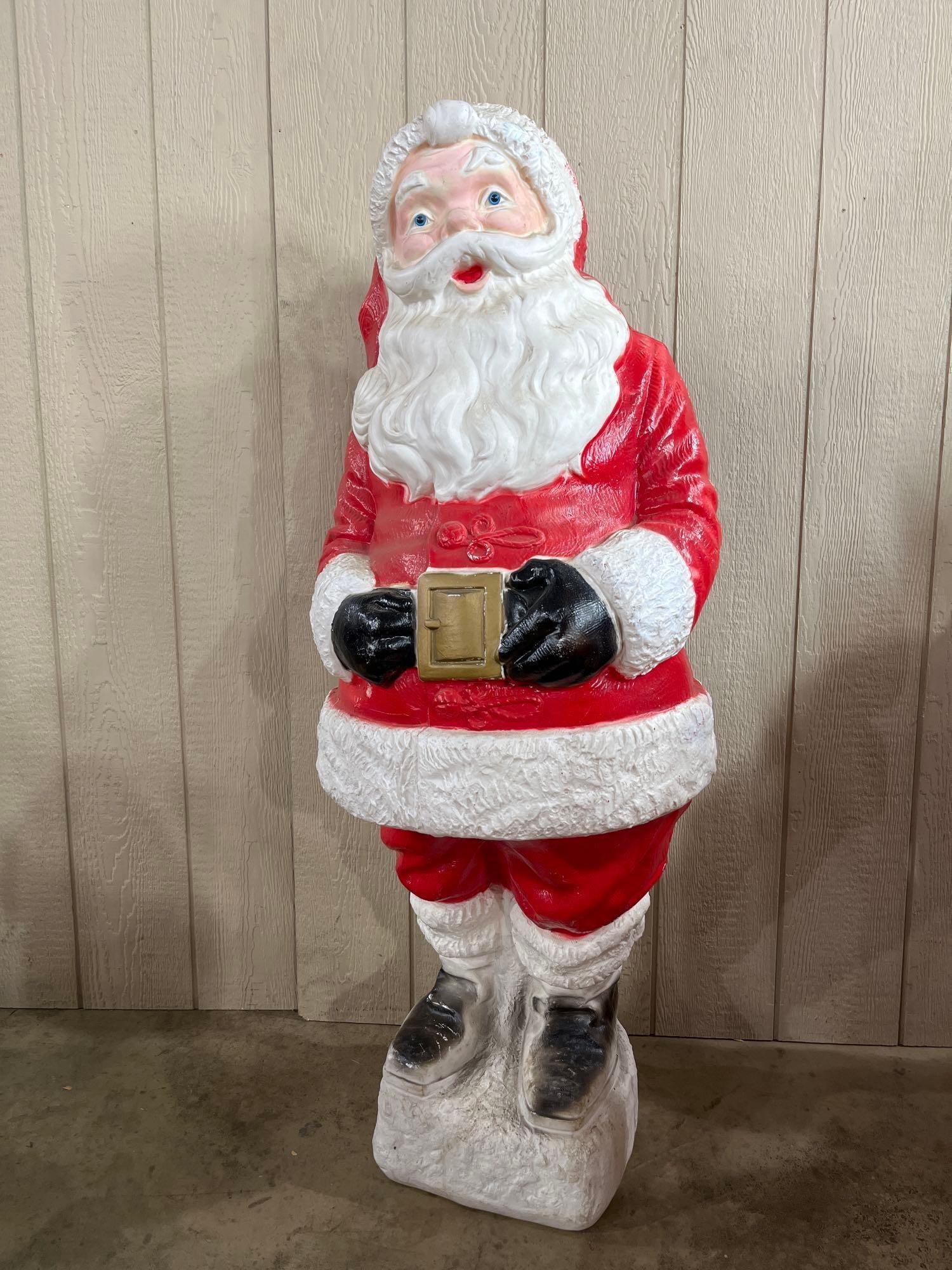 Plastic Santa Claus Lawn Ornament: 54in A large vintage holiday blow mold depicting Santa Claus, constructed from molded plastic. The figure is modeled in a standing pose wearing a traditional red suit with textured white fur-style