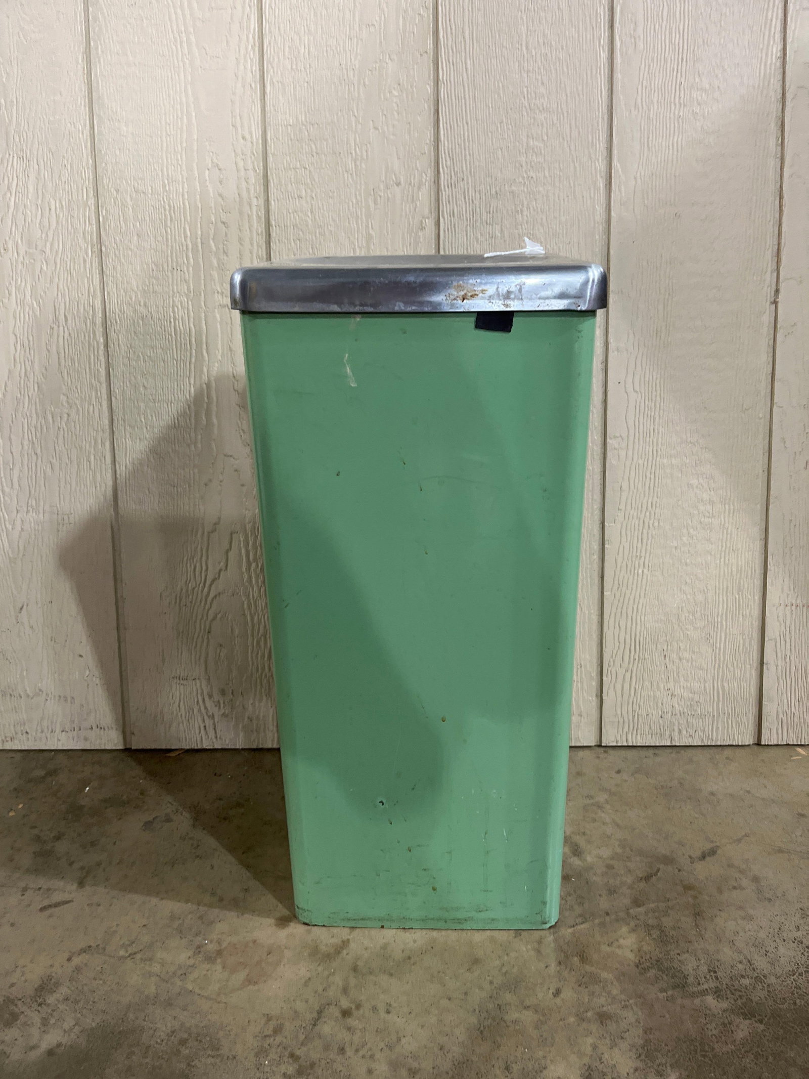 Mid-C. Industrial Green Metal Trash Can: 24x11x11 This floor-standing industrial waste container is designed in a mid-century modern style. The unit features a square, fabricated sheet metal body with a tapered profile toward the base. It is