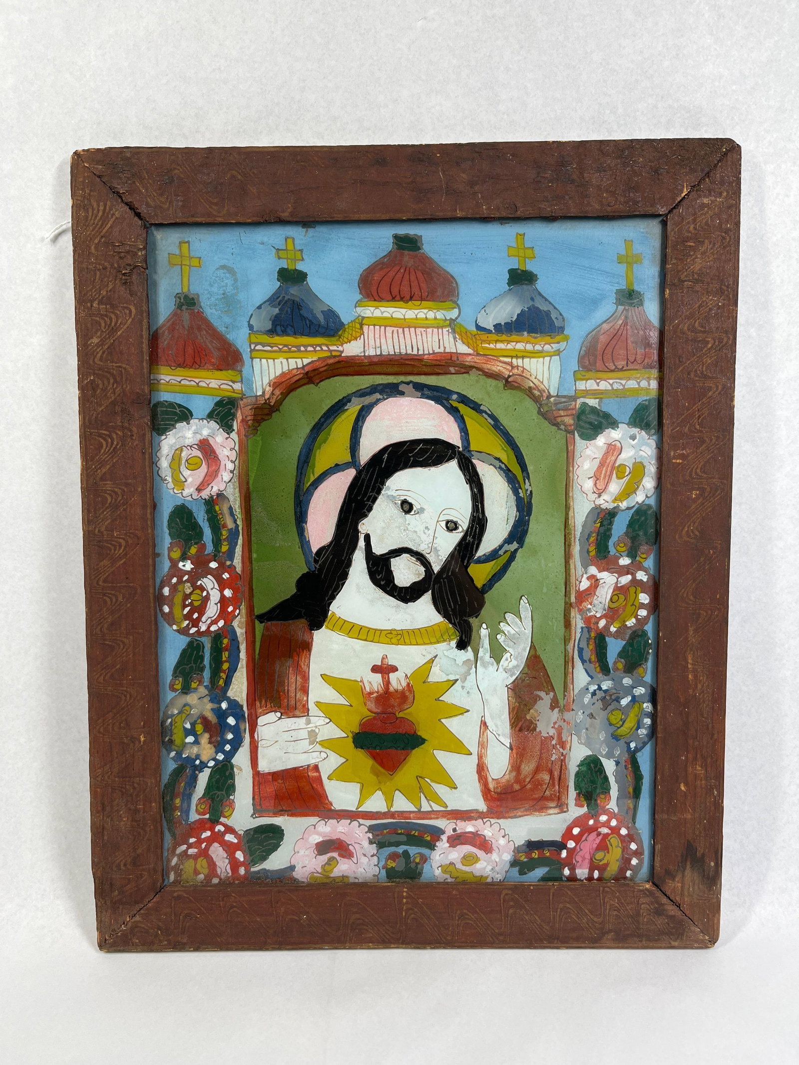 19th C. Central European Sacred Heart: 18x14 This reverse painting on glass, known as Hinterglasmalerei, depicts the Sacred Heart of Jesus in a traditional Central European folk art style. The composition and iconography are consistent