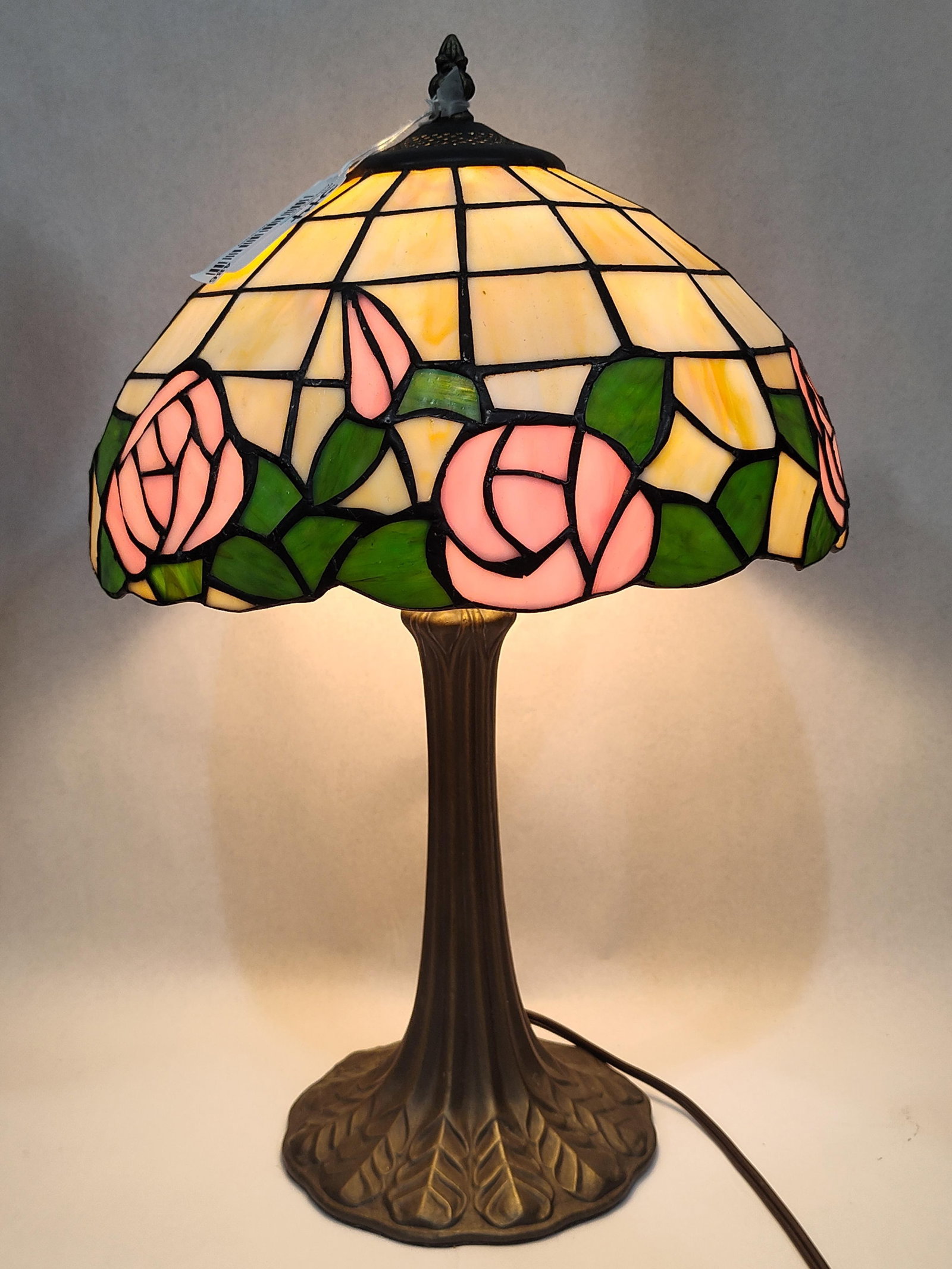 Tiffany Style Leaded Glass Rose Lamp: 20in This table lamp is designed in the Tiffany style and features a domed leaded glass shade. The shade is constructed using the copper foil technique, incorporating pink slag glass roses and rosebud