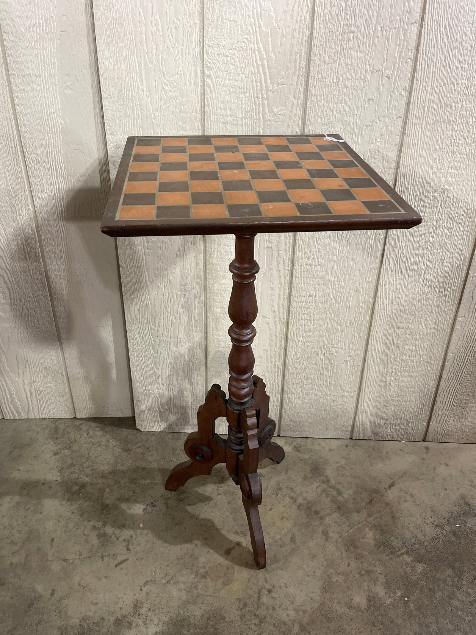 Victorian American Walnut Game Table: A Victorian American pedestal game table, dating to the late 19th century, constructed from walnut with a medium-to-dark reddish-brown finish. The square tabletop features an inlaid 8x8 checkerboard g