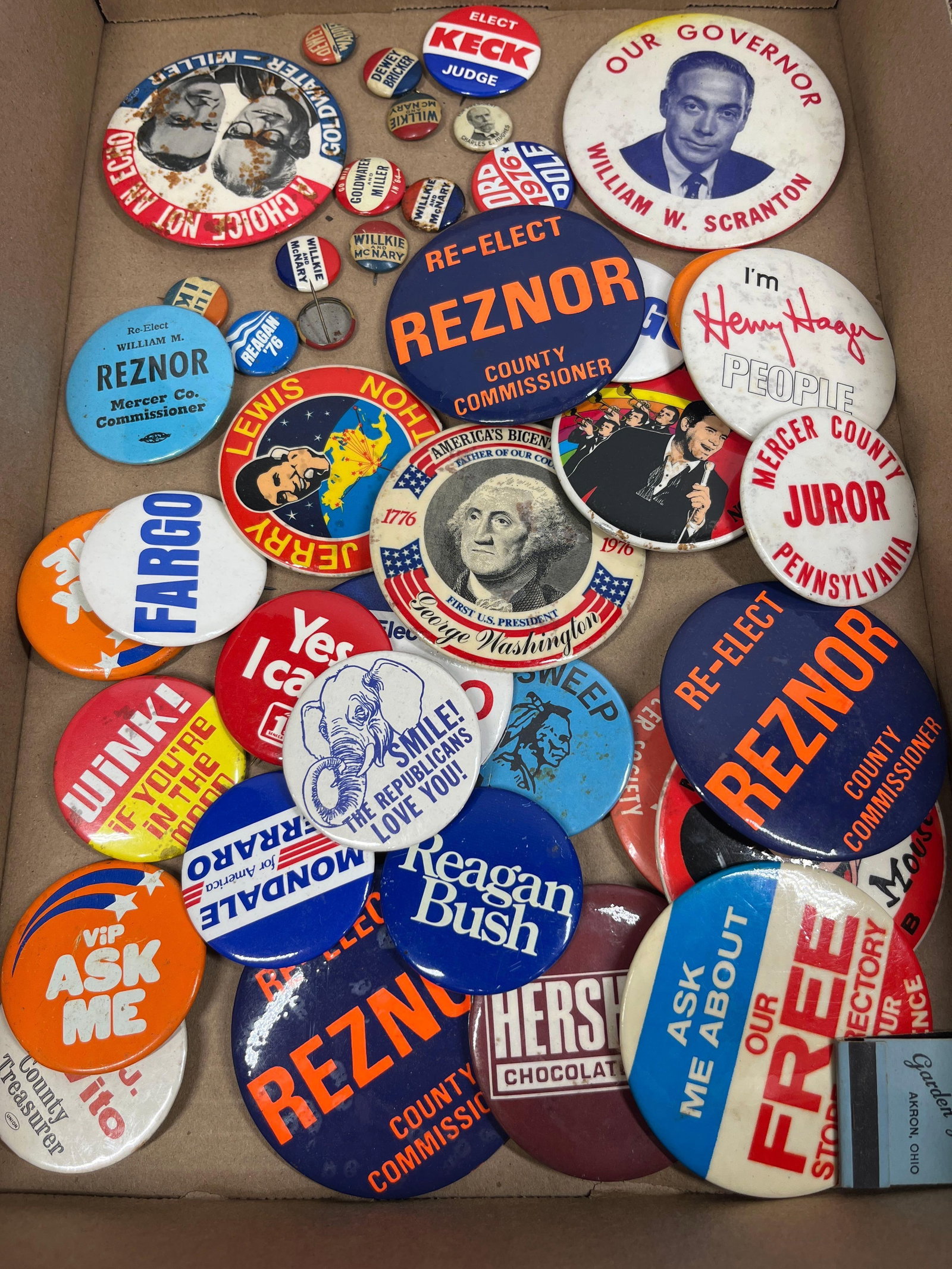 Political Campaign Pinback Buttons: This lot comprises an assortment of vintage pinback buttons and related ephemera, primarily focused on 20th-century United States political campaigns and civic memorabilia. The collection includes a