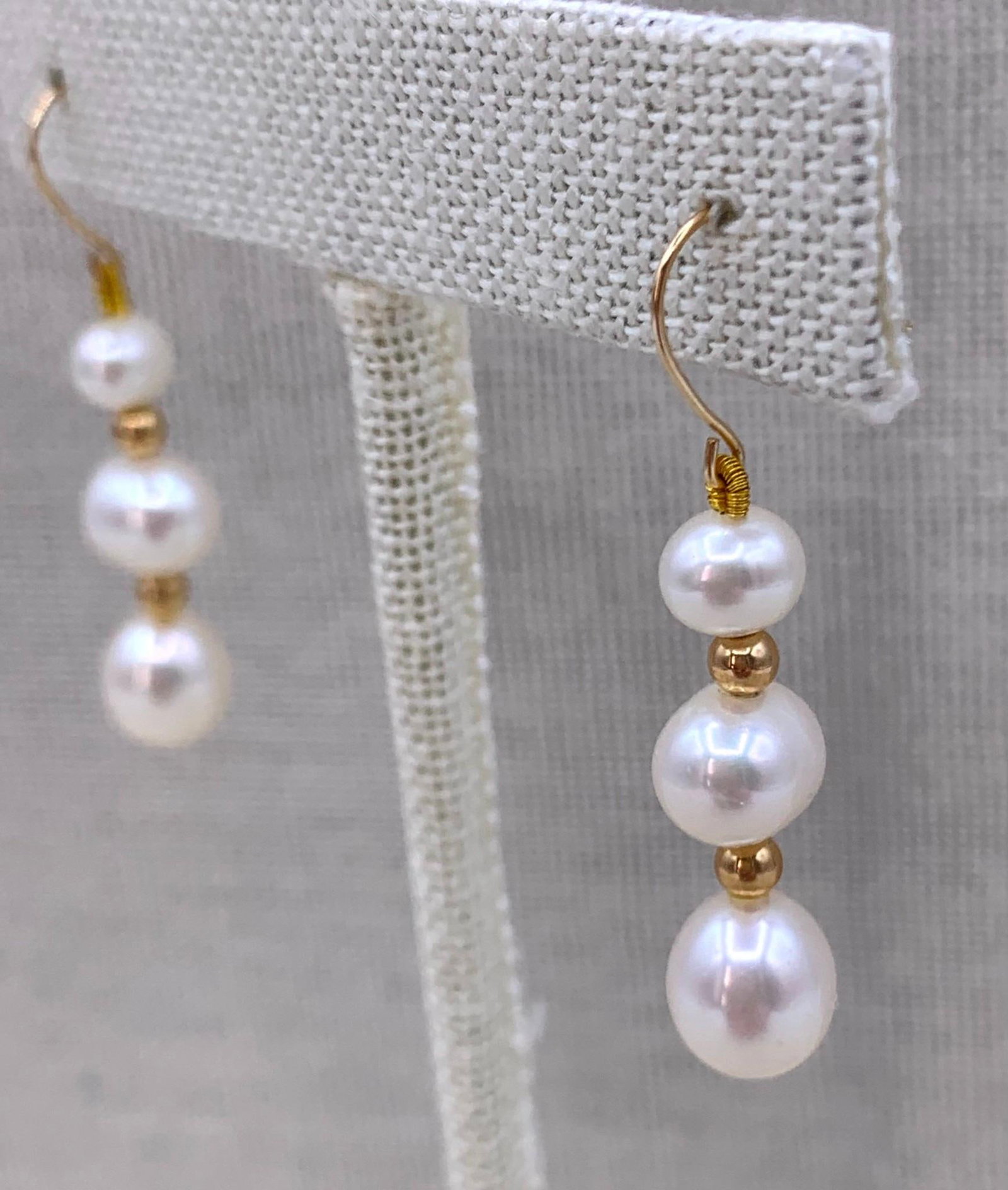 Gleaming 14k Yellow Gold Graduated Triple Freshwater Pearl Shepherd Hook Earrings: 585 hallmarks, 1 1/2" total length, 9mm to 6mm Freshwater Pearls, superb luster.