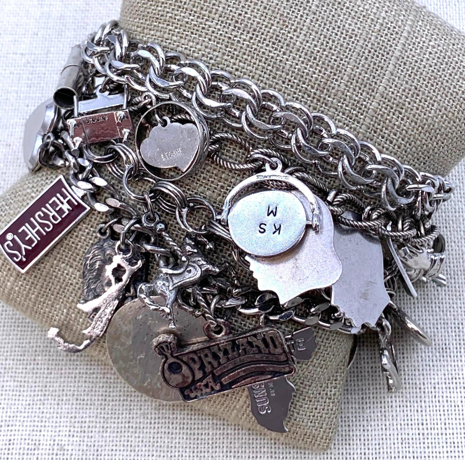 110 GRAM Sterling Silver Vintage Charm Bracelet Collection: Sterling marks on all of the bracelet chains and on many of the charms, one bracelet marked Danecraft and another Elco, working closures, 7", 7 1/8", 7 1/2" bracelet lengths.