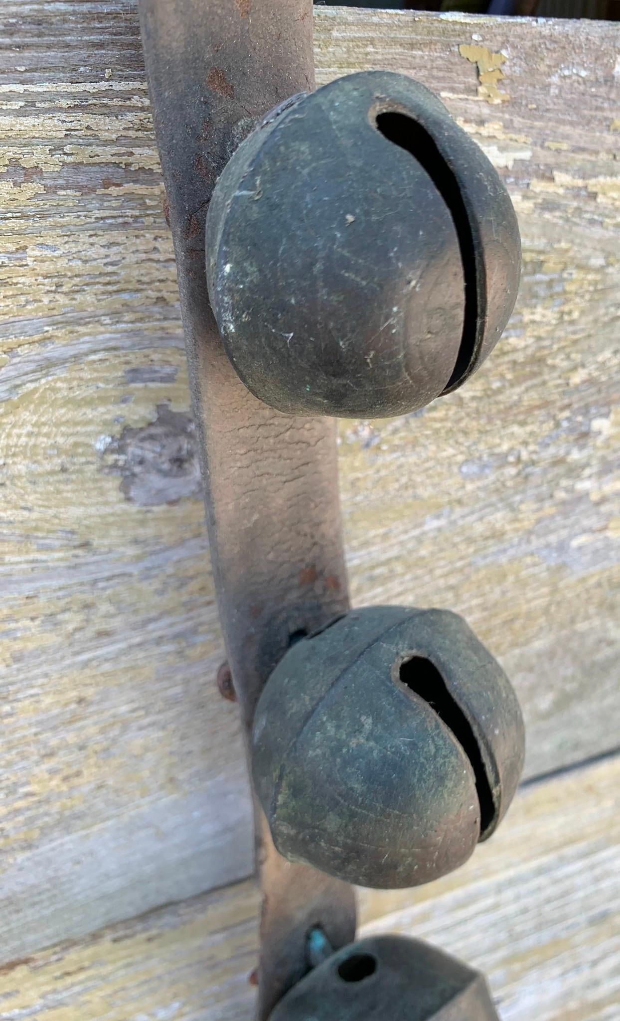 Long Antique Winter Sleigh Bell Graduated Brass Sleigh Bell Strap: 43 1/2" length Early leather strap, 2 5/8" to 1 1/2" brass bells, hefty in weight with lovely jingle.