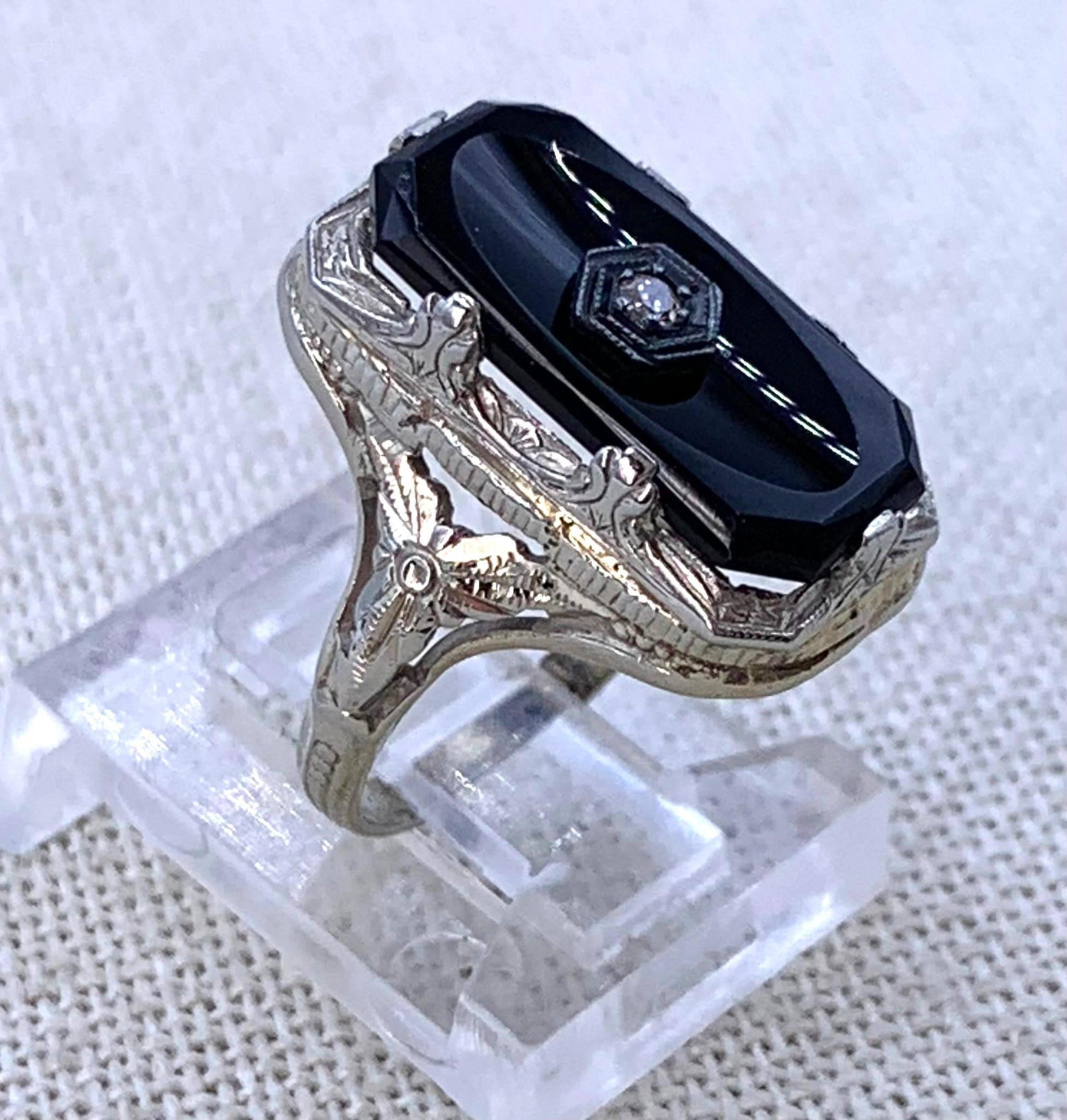 Superb Antique Art Deco 18k White Gold Onyx & Diamond Ring: 18k hallmark, size 4.25, 3.4 gram weight, 16mm x 7.5mm polished concave face Onyx, ornate raised setting with openwork detail and intricate embossed designs, Stunning!
