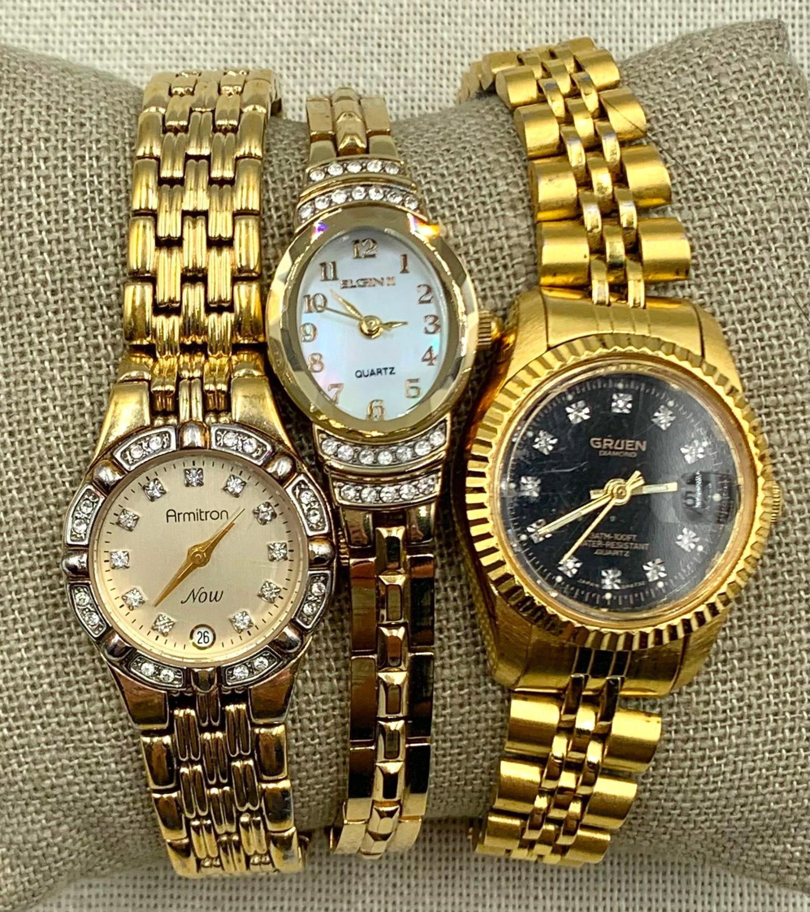 3 Vintage Gruen Diamond Quartz, Elgin II, Armitron Ladies Wristwatches: * Elgin II, mother of pearl face, rhinestone accents, fresh battery needed * Armitron Now, Diamond accents, fresh battery needed * Gruen Diamond Quartz, 100ft water resistant, magnified day, fresh bat