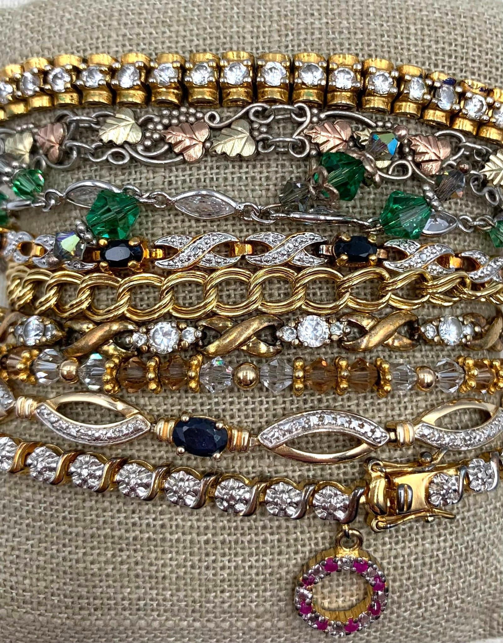 84 Gram 9 pc Sterling Silver, 12k Gold, Bracelet/Anklet Collection: 84 gram combined weight- * 12k Gold 925 hallmarks, Black Hills Gold leaf design bracelet, 7in34; length, one end absent * 6x4mm Sapphire gemstones, 925 hallmark, 7 1/2in34; length, working closure wit