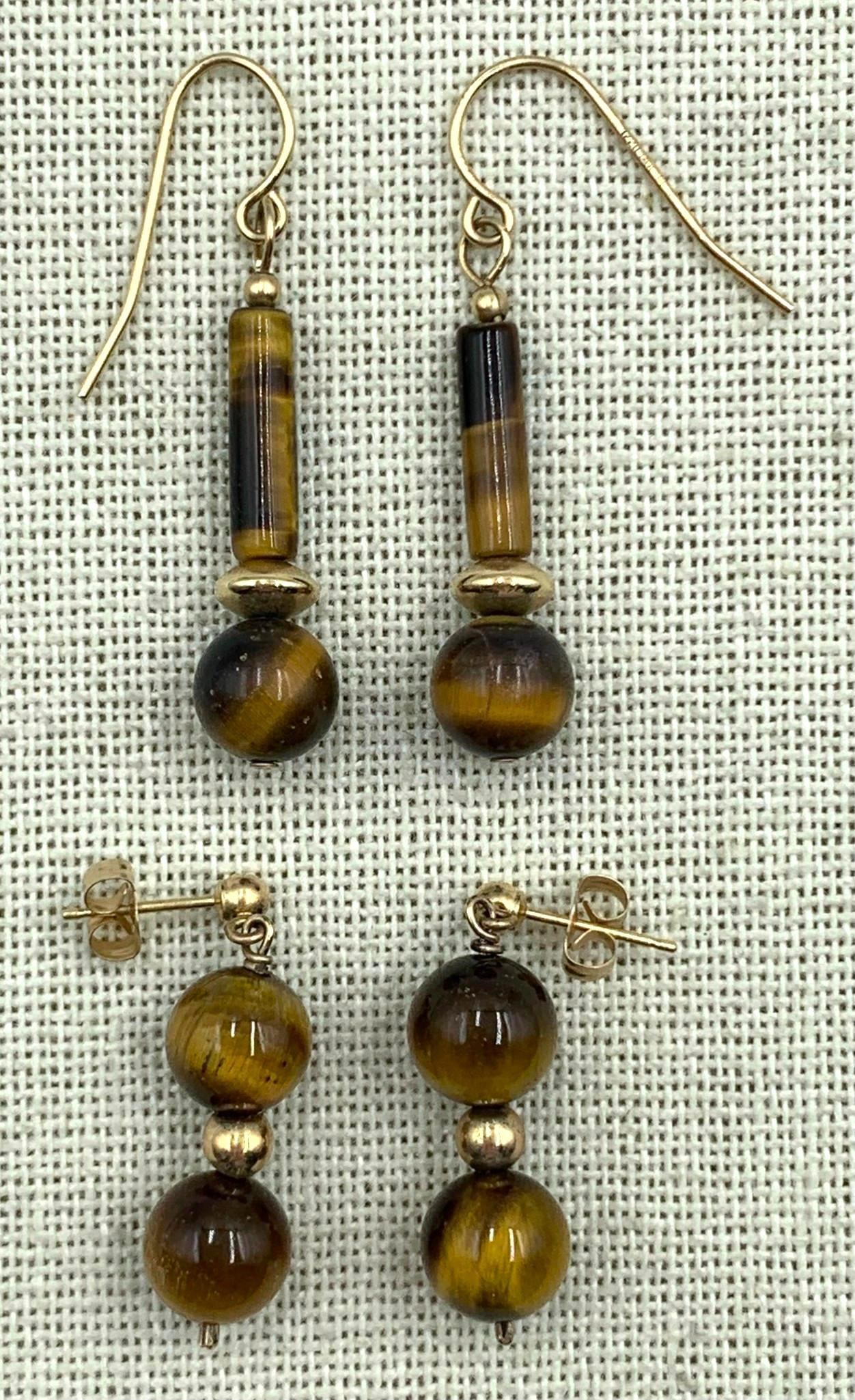 2 Pairs Luminous Tigers Eye Gemstone 14k and 1/20th 12k Gold Pierced Earrings: * 1/20th 12k hallmarked hooks, 1 5/8in34; length, 8mm round and 13mm tube Tigers Eye gems * 14k, 8mm round Tigers Eye gems, 1 1/8in34; length