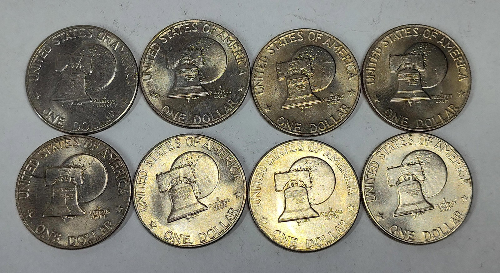 US Bicentennial Eisenhower Dollar Set: A collection of United States Bicentennial Eisenhower Dollars, all bearing the dual date 1776-1976. These coins are struck in copper-nickel clad composition. The obverse features the profile of