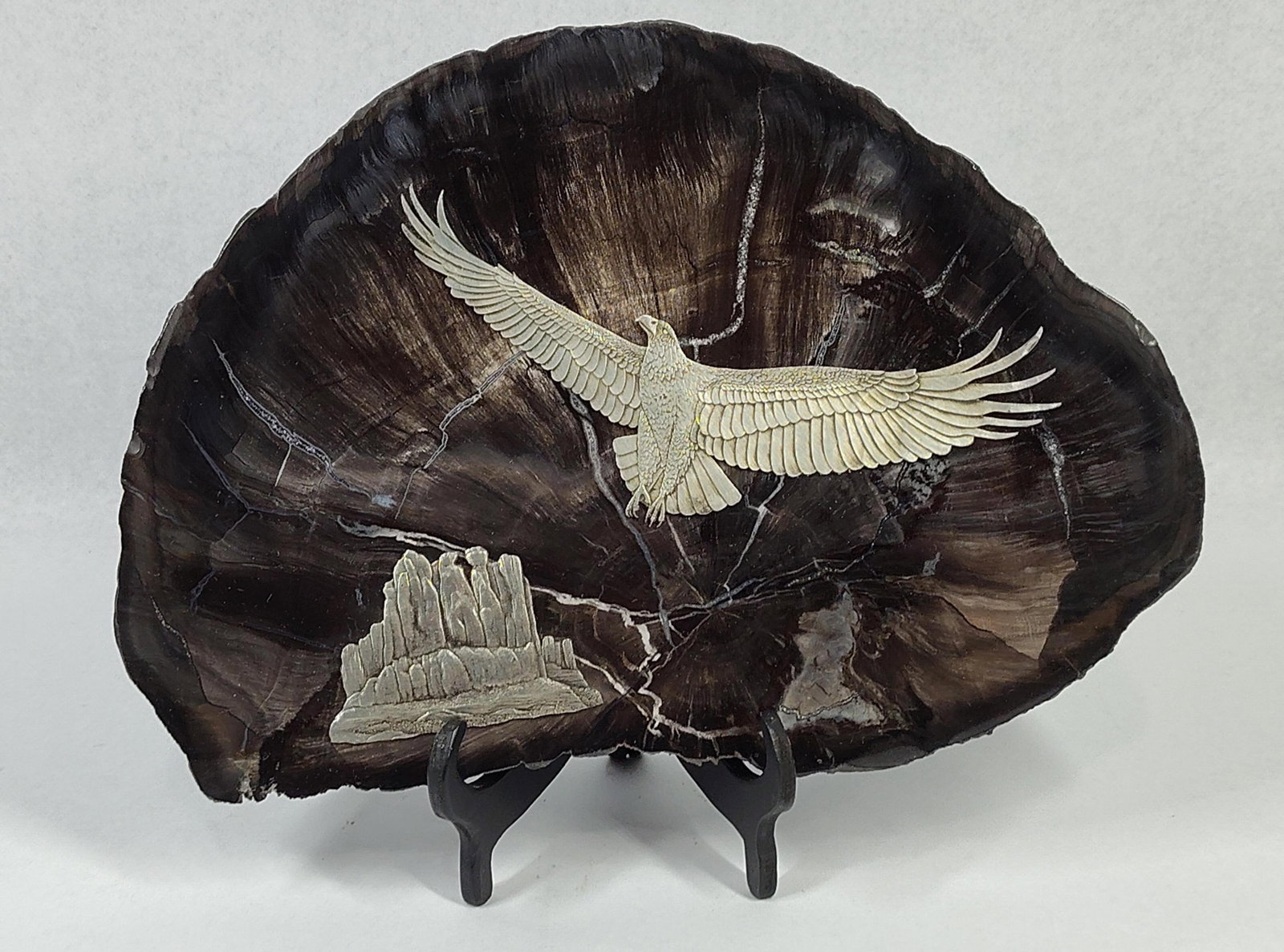 Eagle & Butte Sculpture: 11x8 This Western-themed decorative sculpture consists of a polished, The primary subject is a soaring eagle with finely detailed, outstretched feathers. A second appliqu? in the lower left