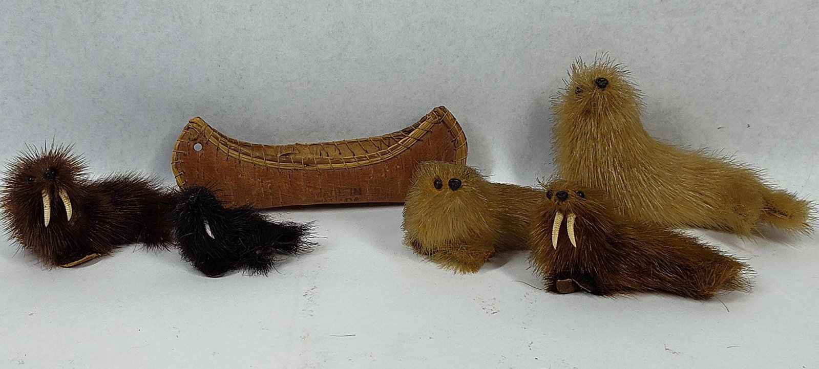 6 Vtg Indigenous Canadian Souvenirs: 2 to 4 inch tall range. A group of six miniature souvenir items consisting of five animal figurines and one birchbark canoe, likely of Indigenous Canadian origin. The collection includes four