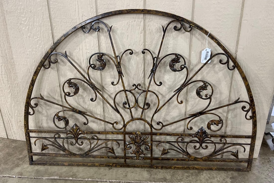 Arched Wrought Iron Fleur-de-lis Grille: 44x30 This large architectural wall element is designed in a demilune or arched transom style, constructed from wrought iron or a similar metal alloy. The piece features a semi-circular outer frame