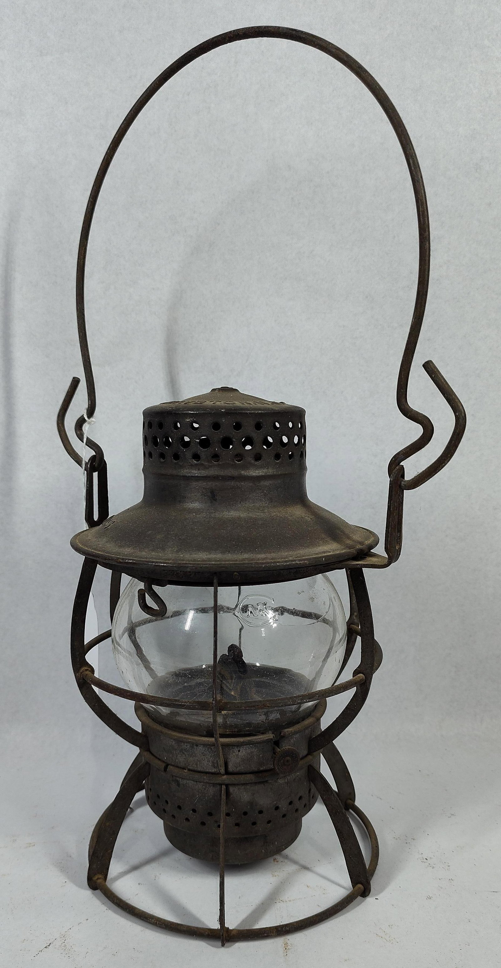 O(3) (1) Dressel(7) (1) Railroad(8): 9 in. This antique railroad lantern was manufactured by Dressel in Arlington, New Jersey, as evidenced by the embossed lettering on the top cap. The clear glass globe is embossed with the letters C