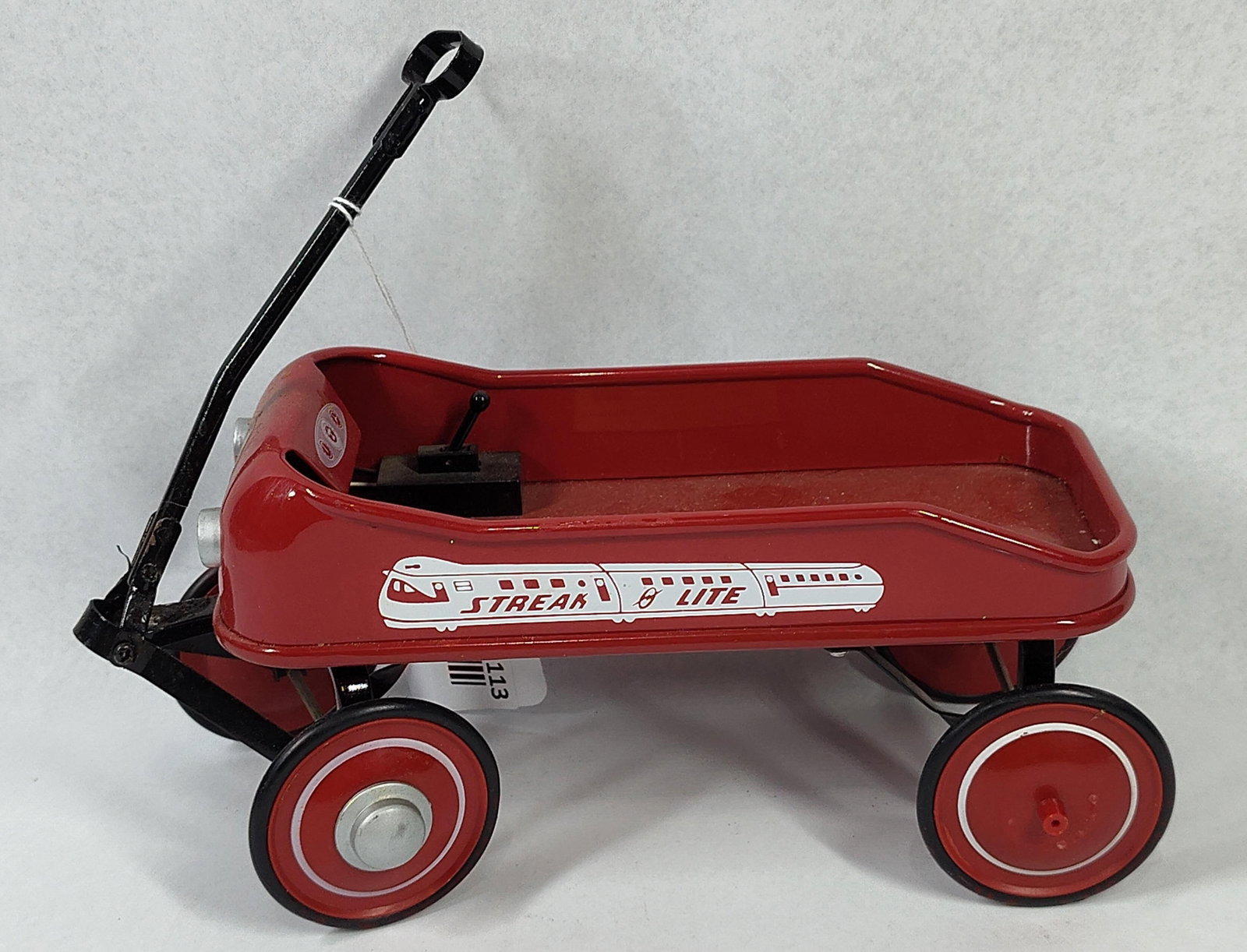 Radio Flyer 80th Streak-O-Lite Wagon: 9x4x3.5This item is a commemorative miniature replica of the Radio Flyer Streak-O-Lite wagon, produced for the company's 80th anniversary. The wagon features a body of red-painted pressed steel