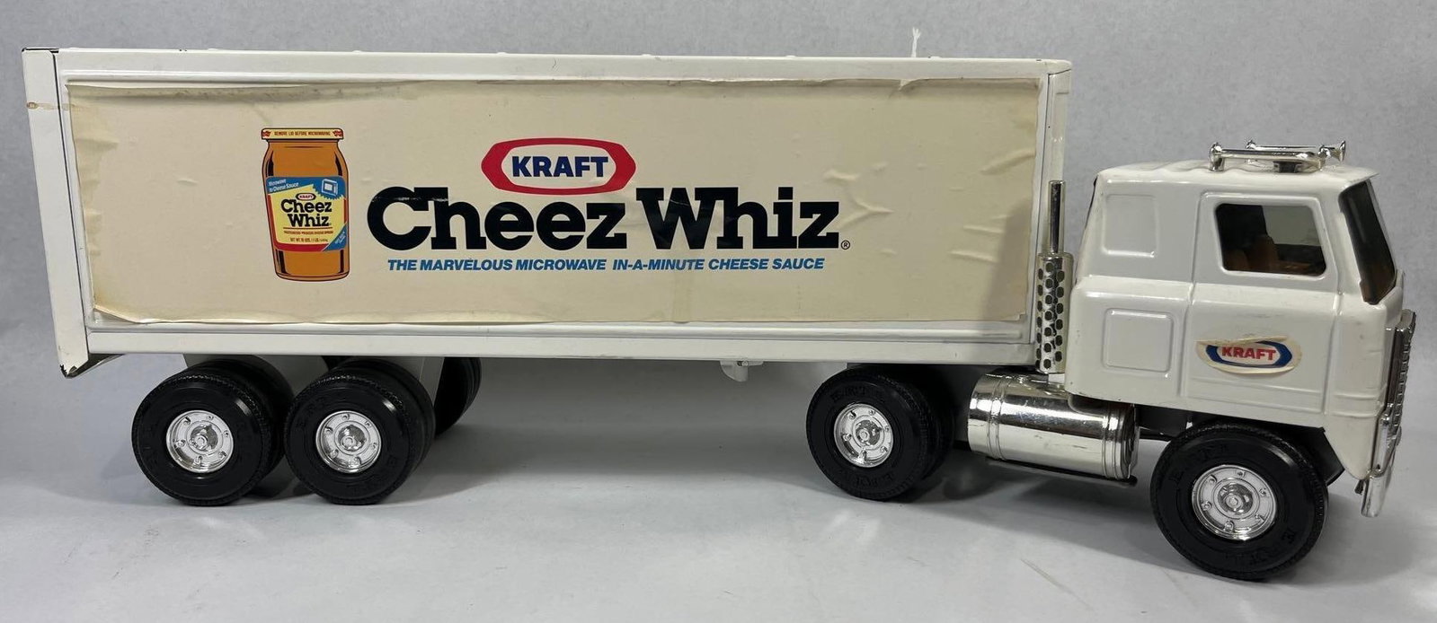 Vtg Ertl Kraft Cheez Whiz Semi-Truck: 21 in. This is a vintage promotional model of a semi-tractor trailer manufactured by Ertl. The tractor is a cab-over-engine (COE) design with the name International cast into the front grill. Both the