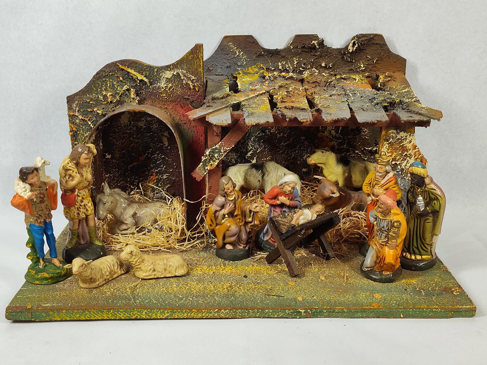 Italian 14-Piece Nativity Set & Stable: A vintage nativity creche set consisting of a rustic stable and 14 separate pieces. The stable structure is constructed from wood, cork, and various composite materials with a textured, painted