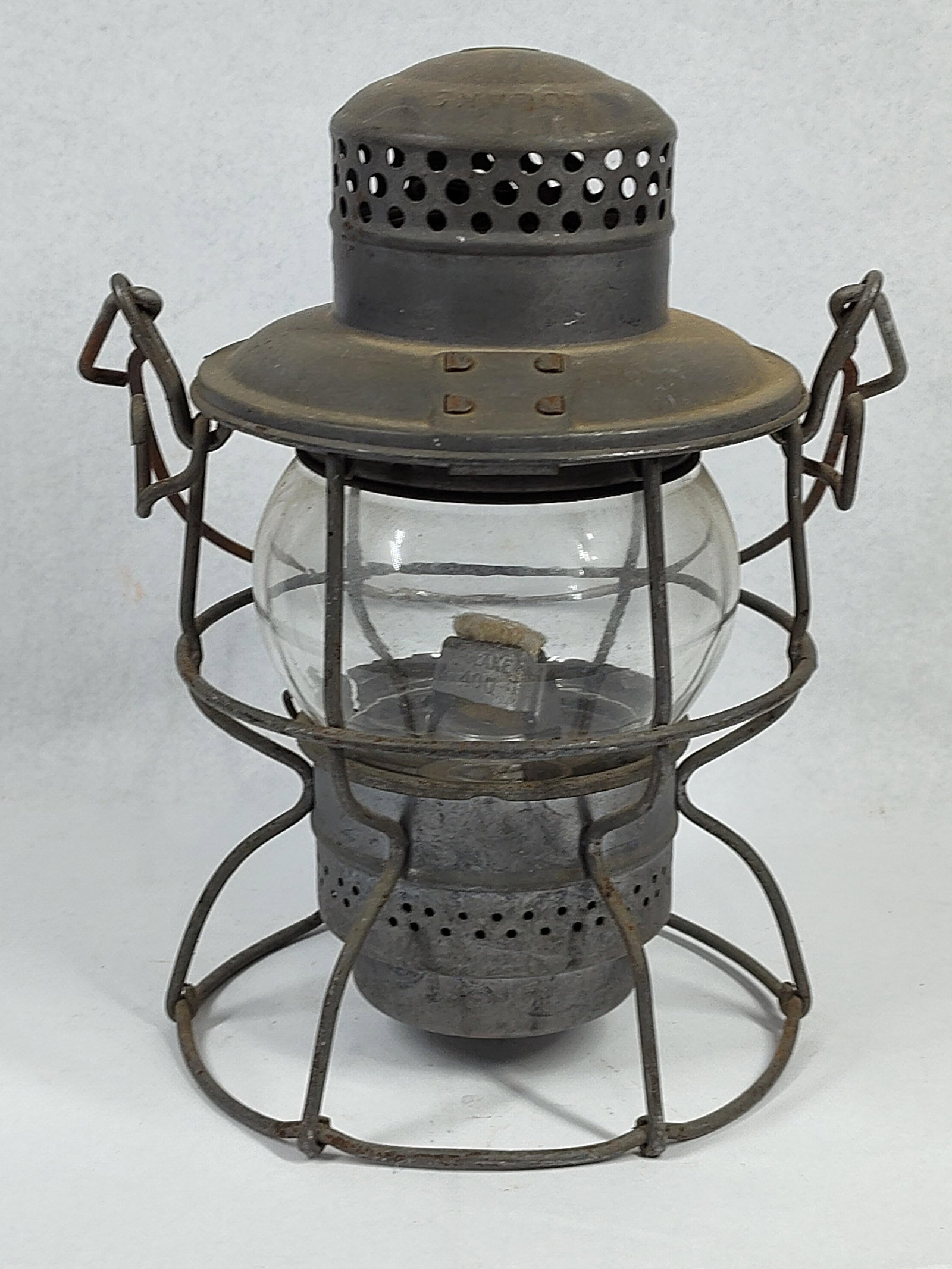 Adlake Kero Penn. RR Globe Lantern: 9 in. This railroad lantern is an Adlake Kero model manufactured by Adams & Westlake for the Pennsylvania Railroad. It features a tall-globe design with a steel wire guard cage protecting a