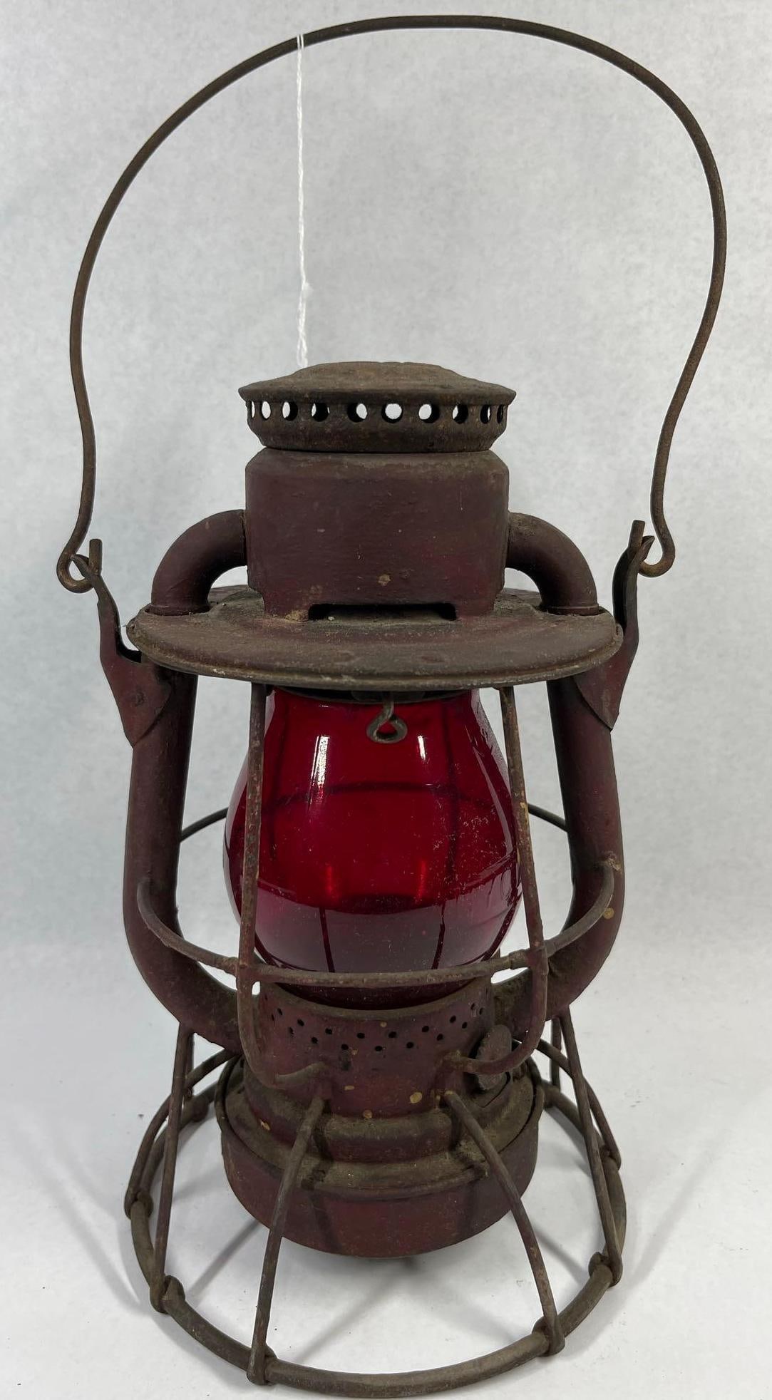 Dietz Vesta NYC Lines Red Globe Lantern: 11 in. This antique Dietz Vesta short-globe railroad signal lantern was manufactured for the New York Central Lines. The lantern features a steel frame construction with a wire-guard cage and a red
