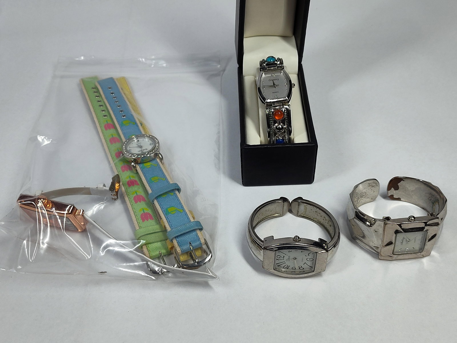 Gramercy & Vivani Women's Watches (5): This collection features five women's wristwatches in various styles, all powered by quartz movements. Included is a Gramercy silver-tone cuff watch with a tonneau-shaped dial and an ornate band s
