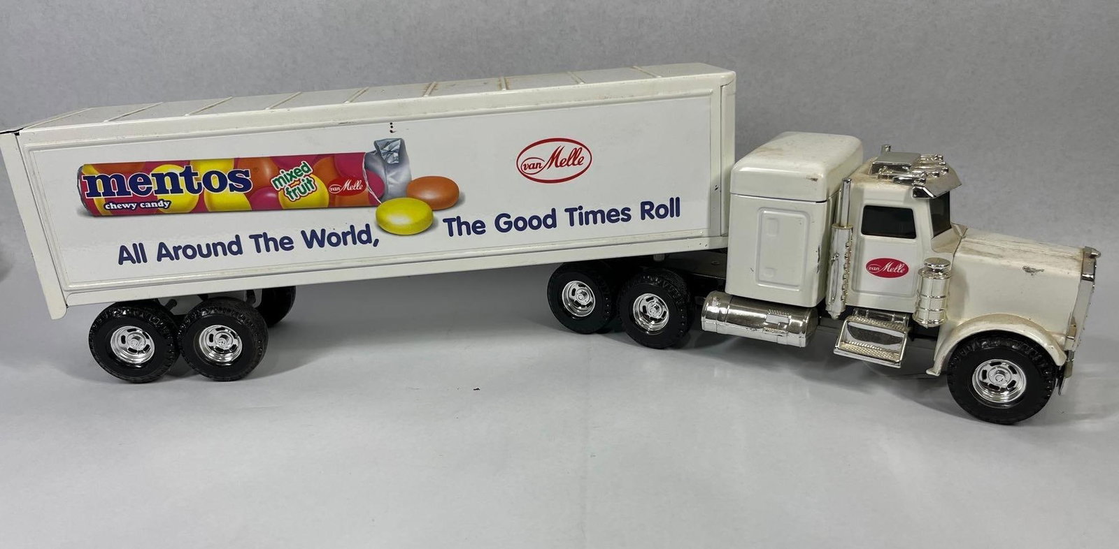 Peterbilt Semi-Truck & Mentos Trailer: 21 inches. Attributed to ERTL, this vintage advertising tractor-trailer unit features branding for Mentos Chewy Candy and van Melle. The set includes a white conventional cab and a detachable white