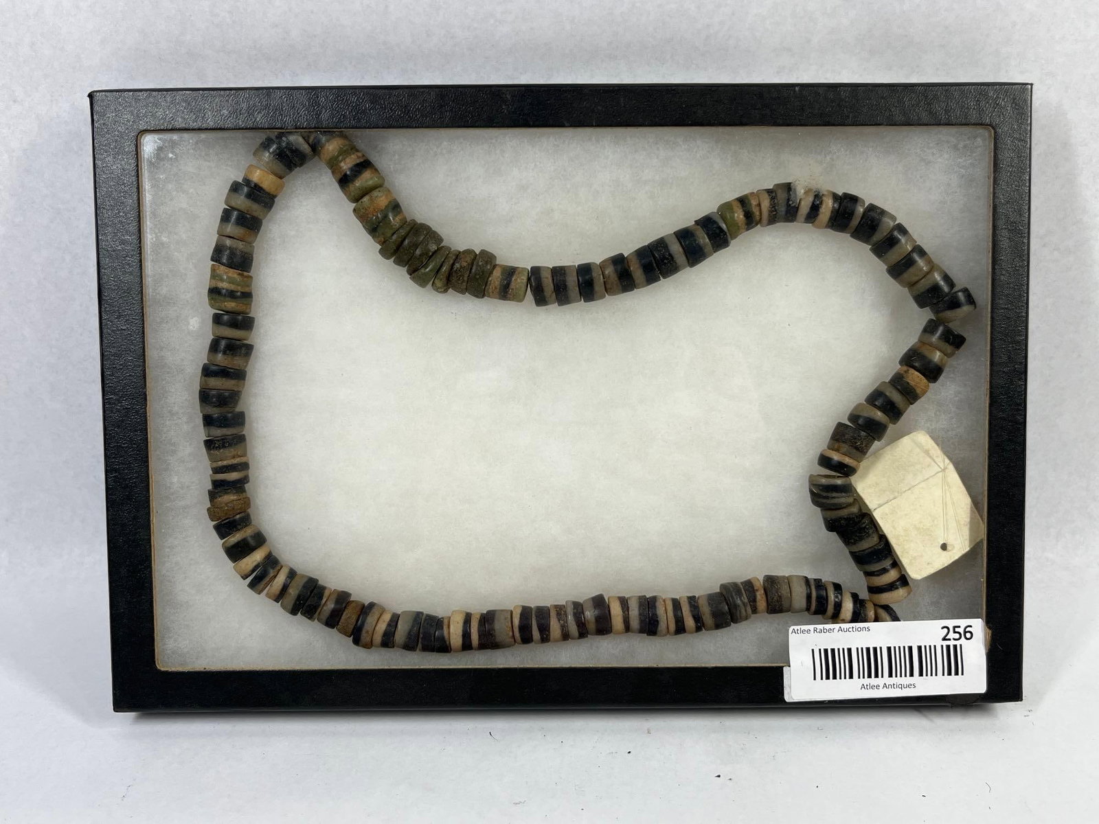 Antique Banded Agate & Stone Beads: Approximately 10 in diamter. A strand of hand-cut stone beads, primarily composed of banded agate or jasper, executed in a heishi style. The collection features a variety of irregular disc-shaped and