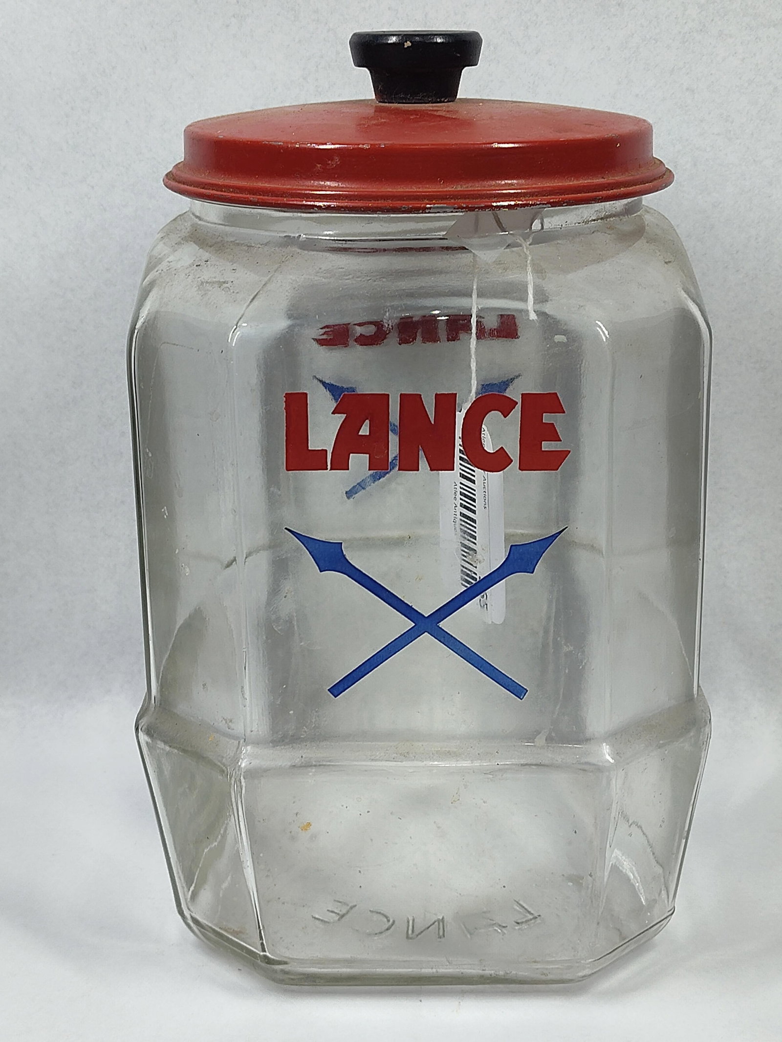 Lance Octagonal Glass Advertising Jar: 10.5x8x9 This vintage advertising countertop display jar was produced for Lance, Inc., an American snack food manufacturer. The clear glass vessel features an eight-sided octagonal body with a