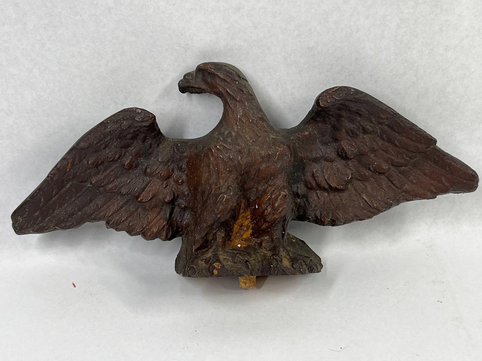 Composition Eagle Regulator Finial: This decorative figurine is a spread-wing eagle finial, designed as an architectural topper for a regulator clock case. The piece is crafted from a molded composition or wood-pulp material that simula