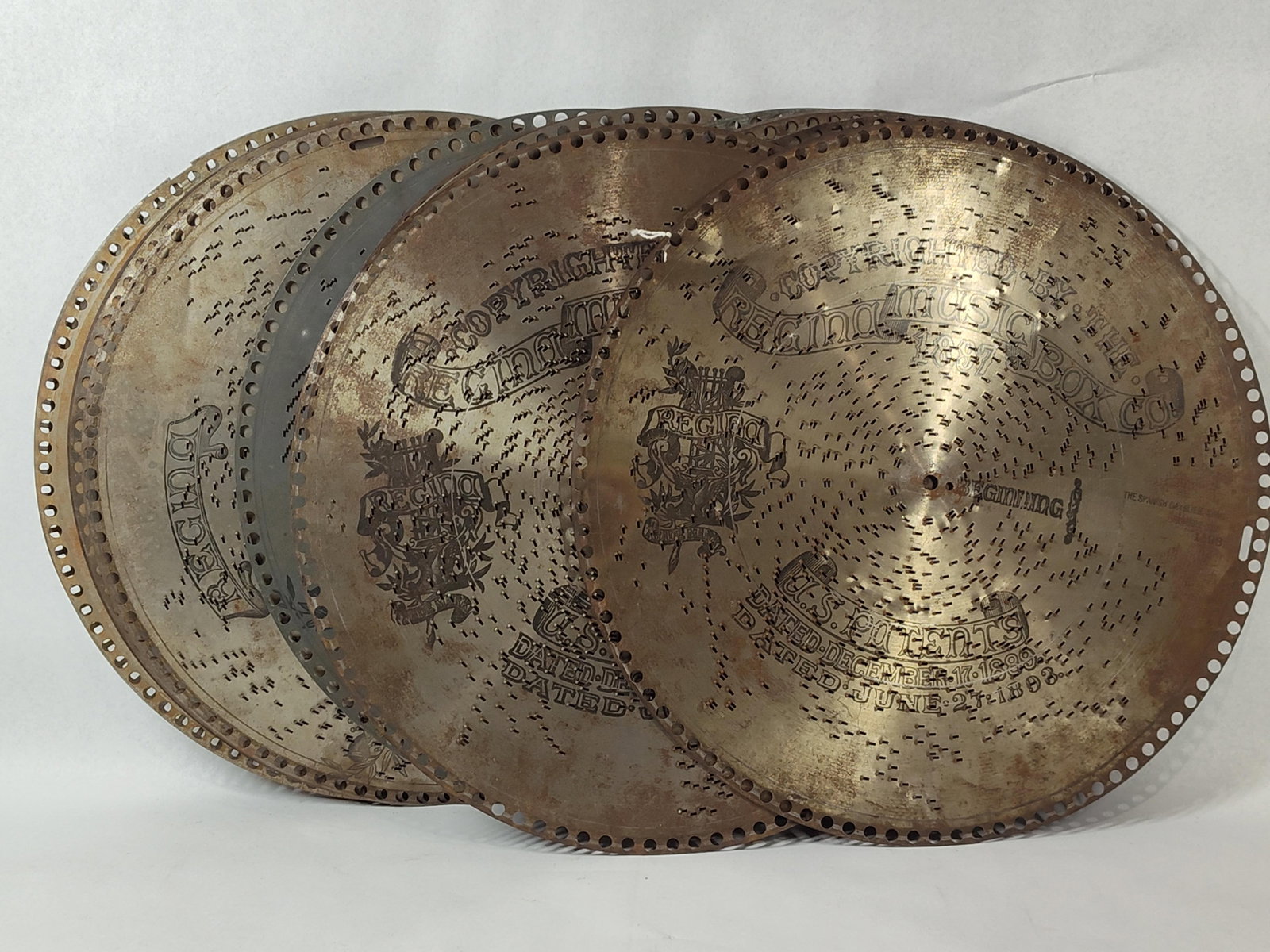 Regina 15.5" Music Box Projection Discs: 15.5 inches - 15 discs. This collection consists of five stamped steel projection discs manufactured by The Regina Music Box Co. of Rahway, New Jersey. These discs were designed for use in a