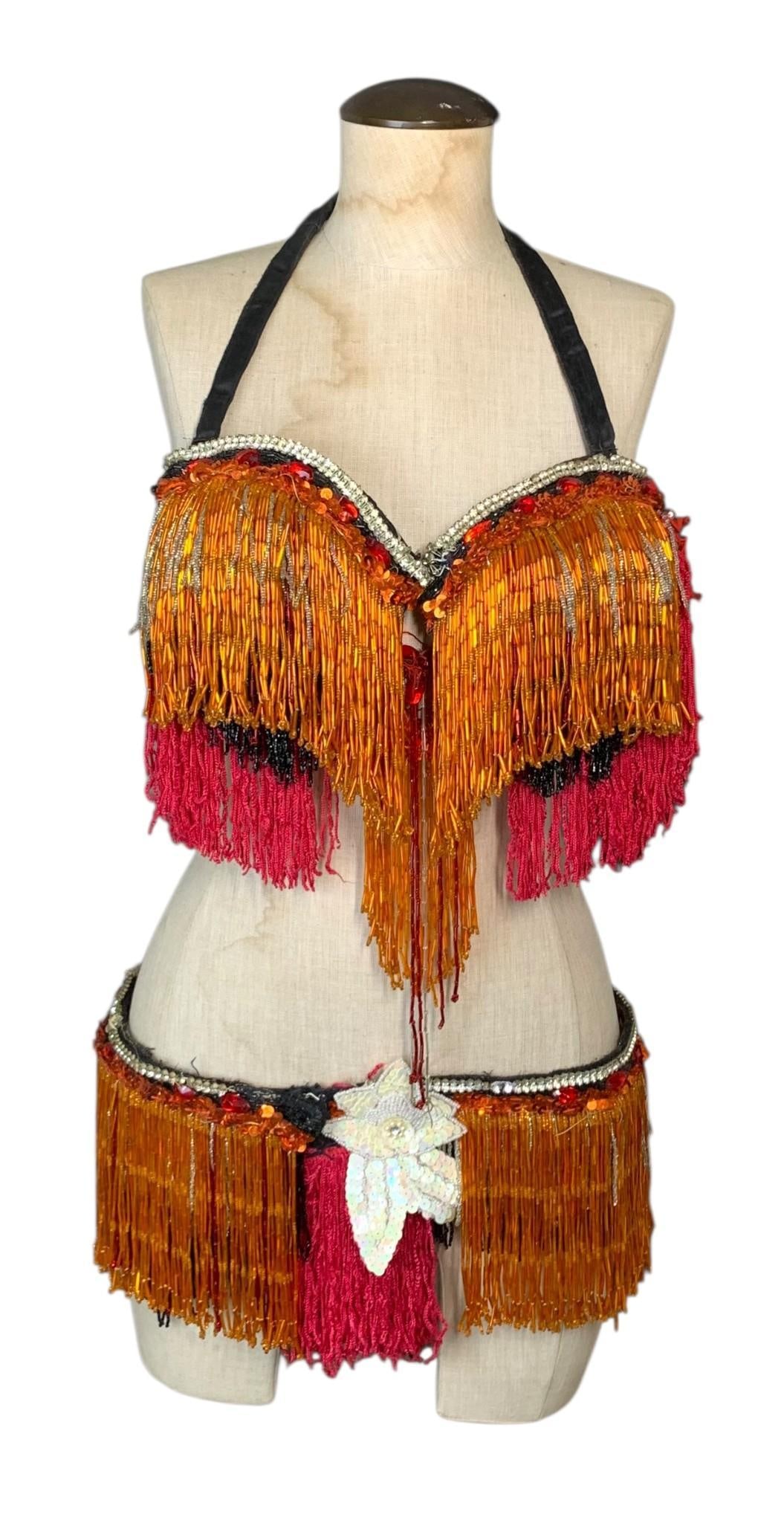 Vtg Beaded Belly Dance Costume & Photos: This lot comprises a two-piece professional-grade bedlah style belly dance costume and a collection of four original black and white promotional photographs. The ensemble, dating from the late 1960s