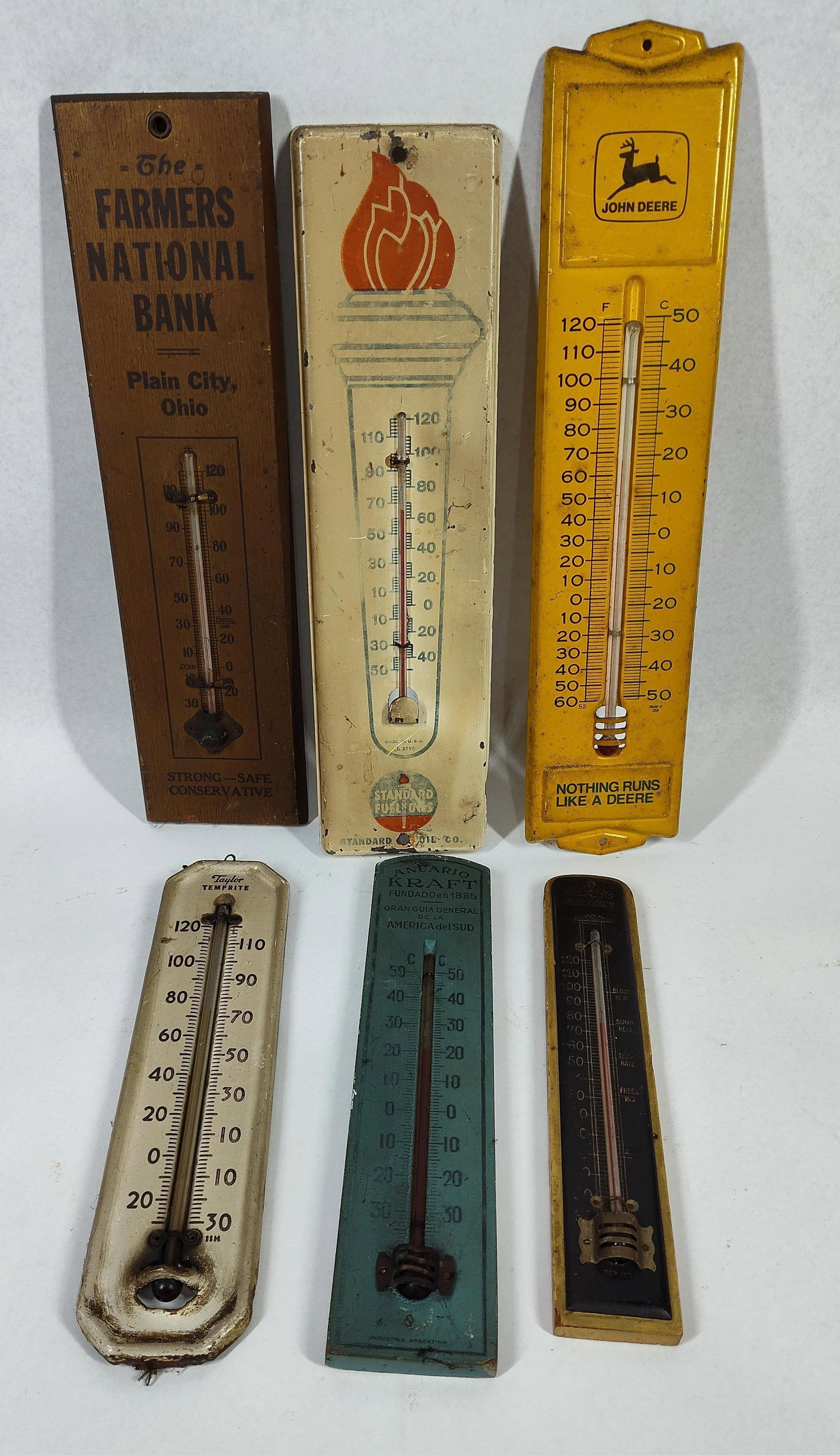 Vtg John Deere & Standard Oil Therms: 8 in to 11.5 in. A collection of six vintage advertising and household thermometers featuring a variety of materials and brands. The assortment includes: One embossed yellow metal John Deere