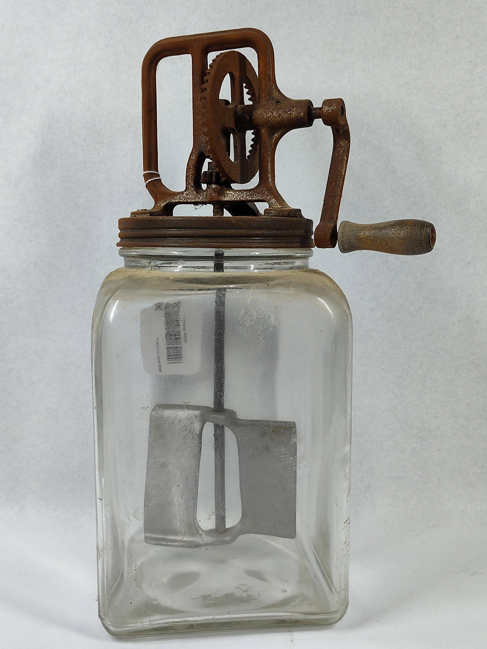 Hazel-Atlas Glass Crank Butter Churn: 14x8x8 An antique hand-cranked glass butter churn, typical of early 20th-century American farmhouse kitchenware. The item consists of a square-profile clear pressed glass jar base and a heavy cast